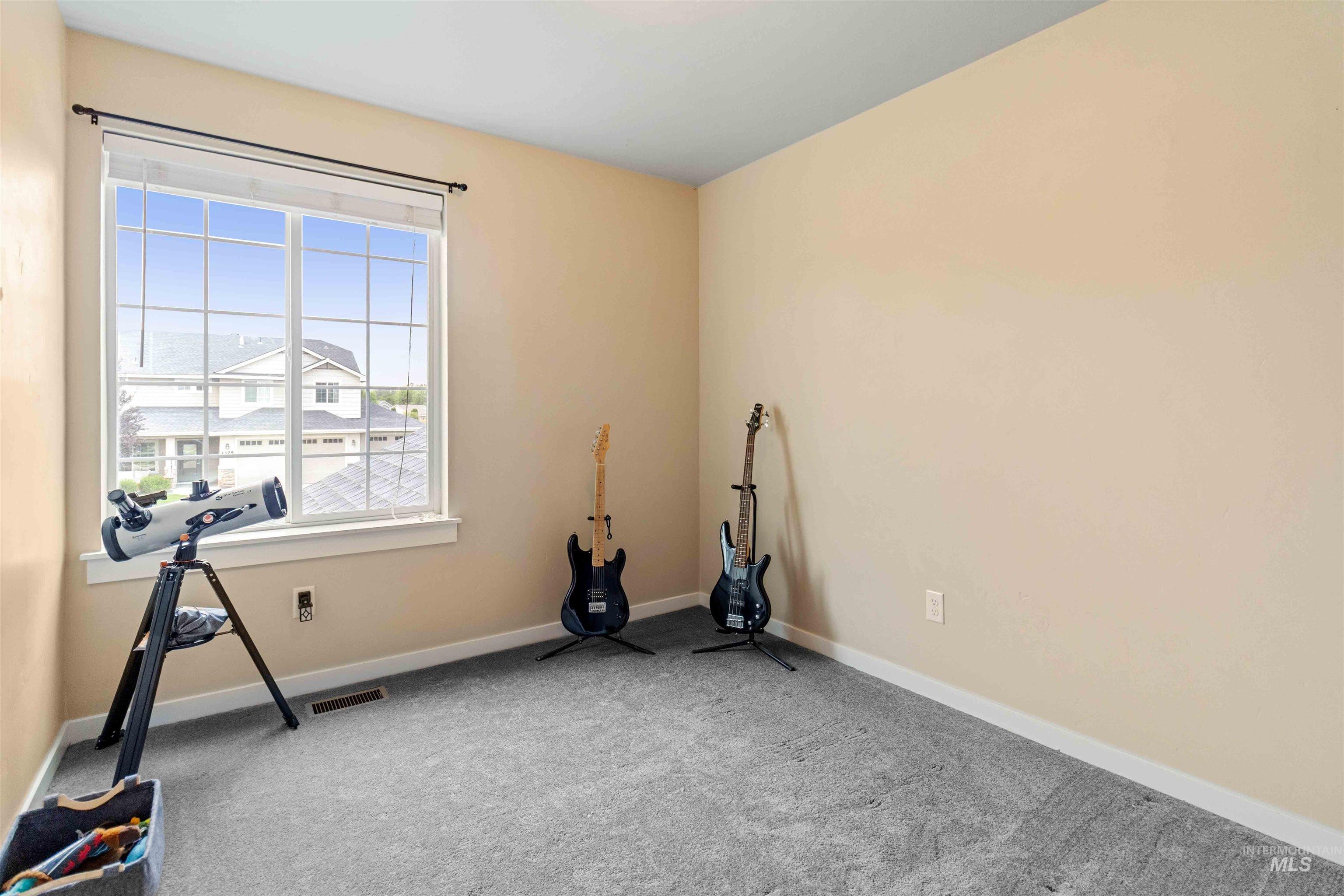 Workout room featuring carpet and baseboards