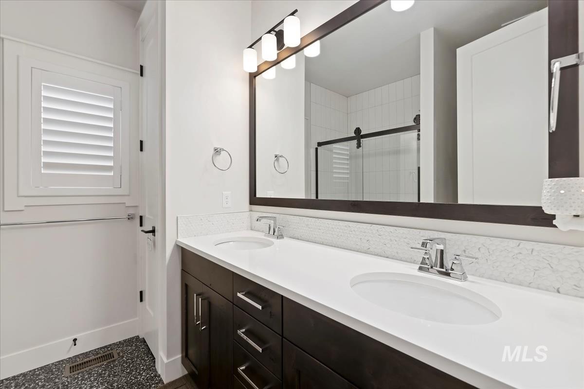 Full bathroom with a stall shower and double vanity
