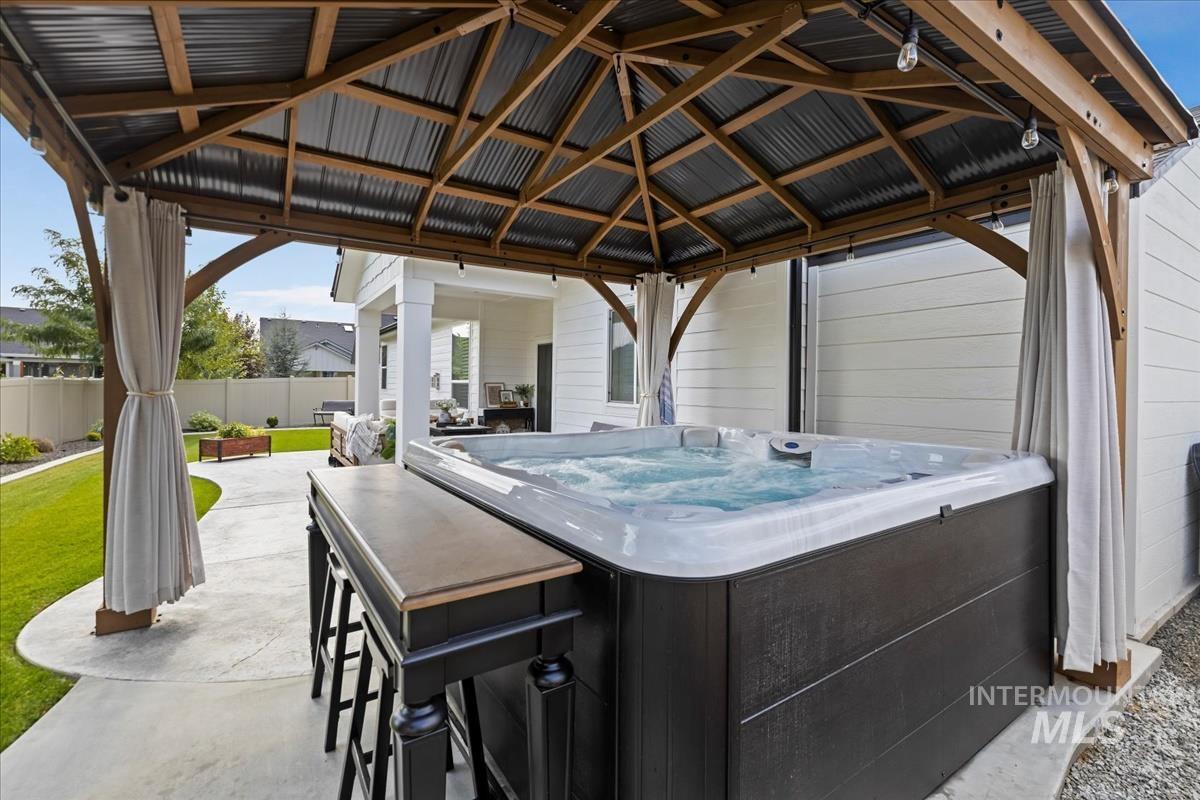 View of patio with a gazebo and a hot tub