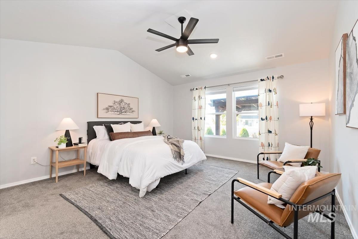 Carpeted bedroom featuring lofted ceiling, ceiling fan, and recessed lighting
