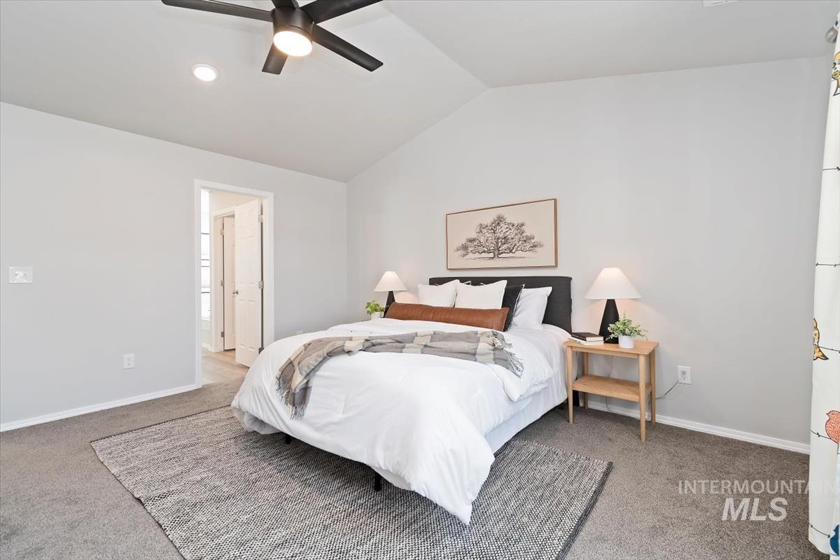 Bedroom featuring vaulted ceiling, light carpet, a ceiling fan, and recessed lighting