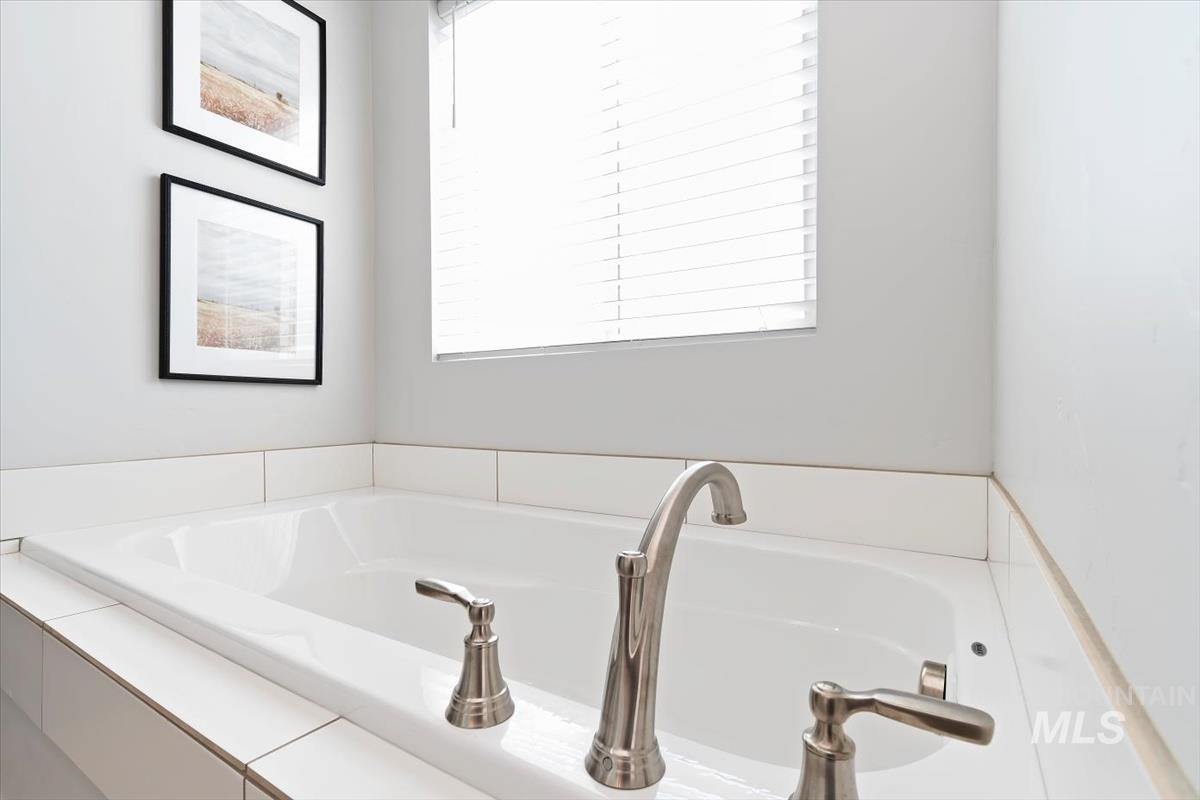 Full bathroom with a bath and plenty of natural light