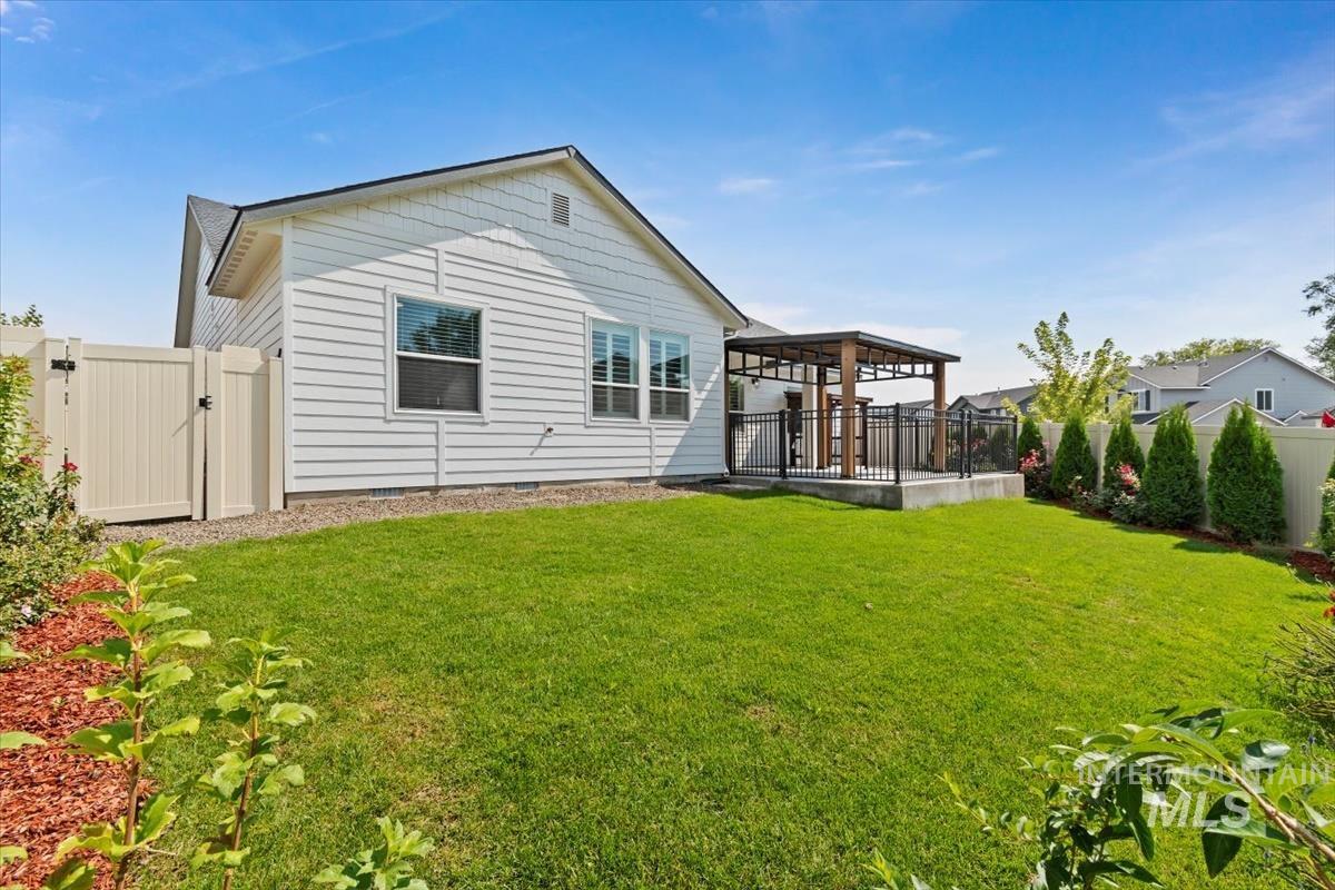 Rear view of house featuring crawl space, a gate, a gazebo, and a deck