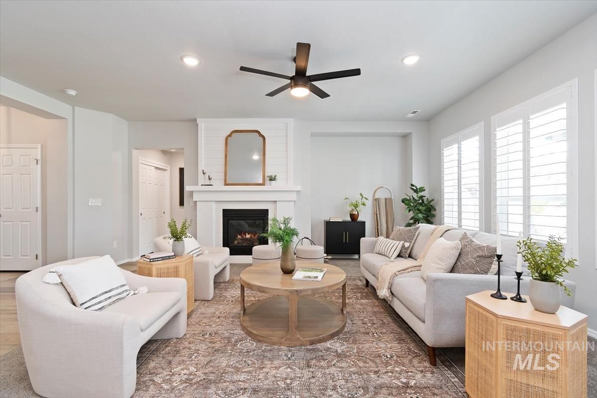 Living area featuring a ceiling fan, a fireplace, and recessed lighting