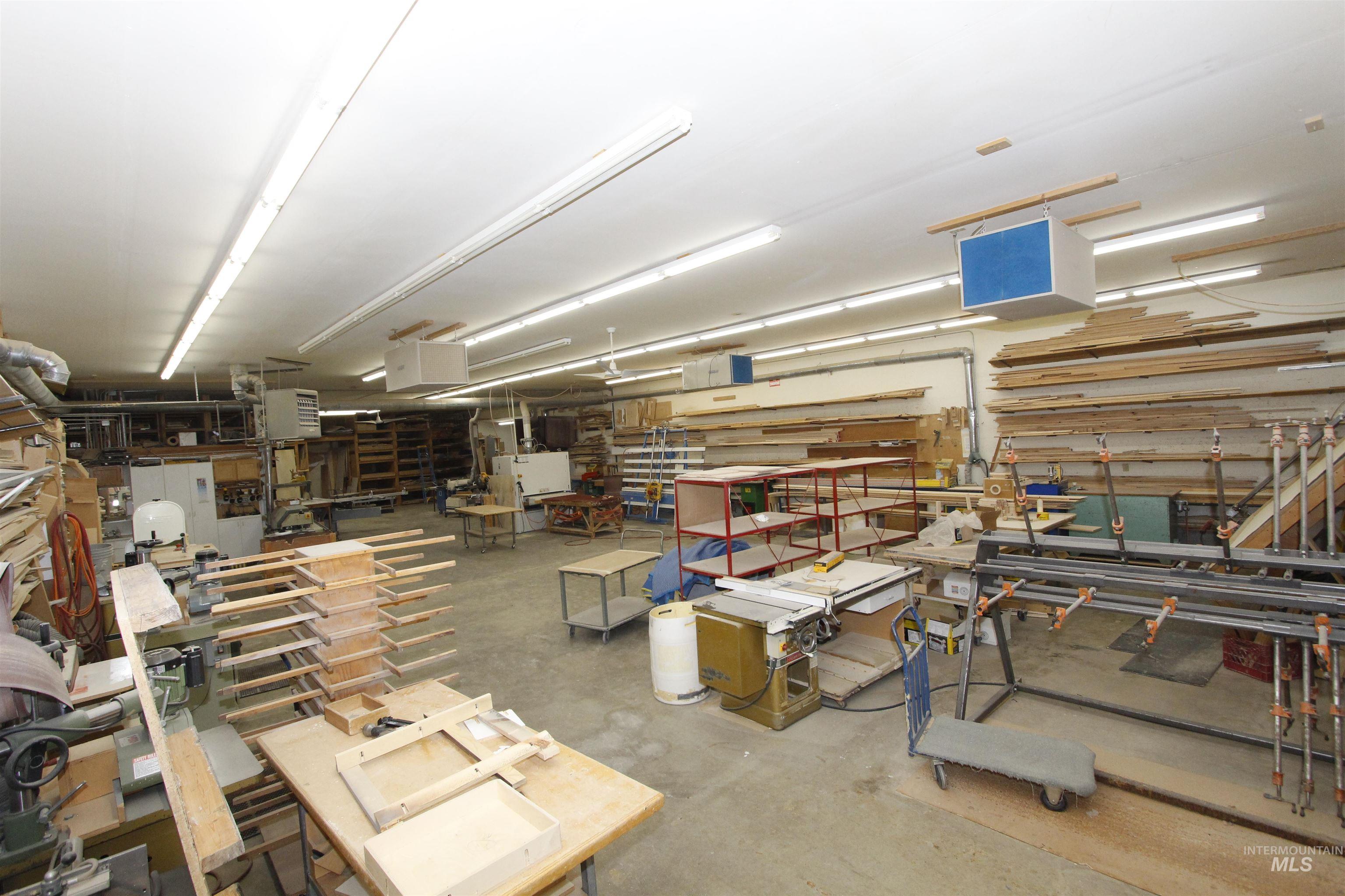 Garage featuring a workshop area and a heating unit