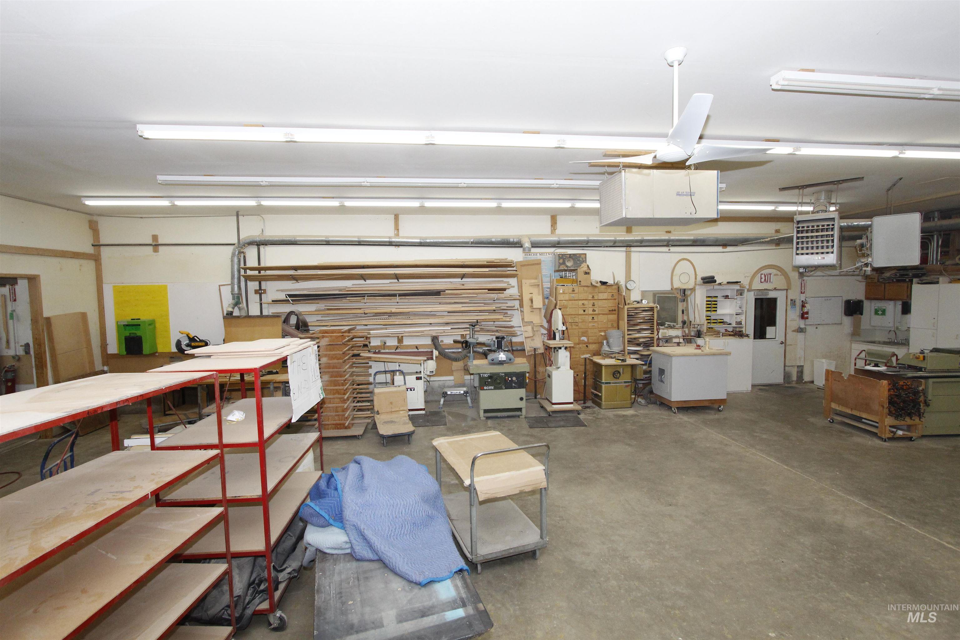 Garage featuring a heating unit and a workshop area
