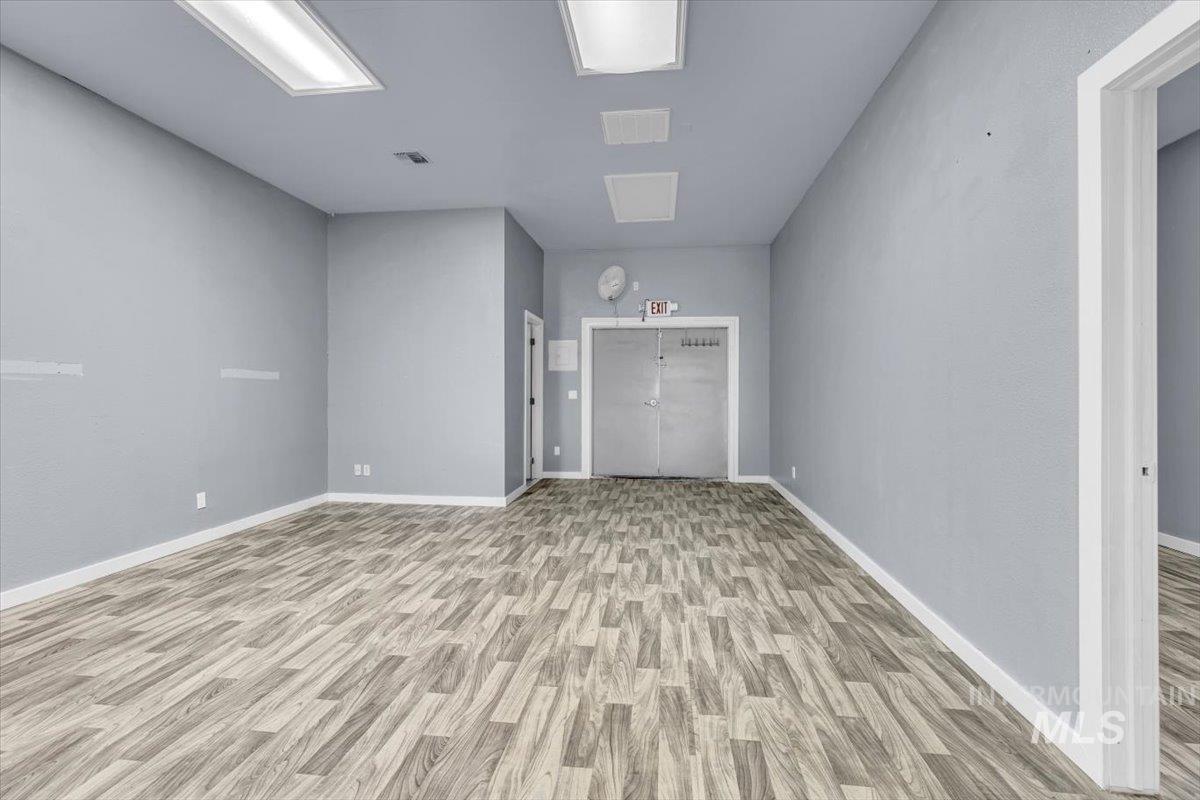 Unfurnished room featuring light wood-style flooring