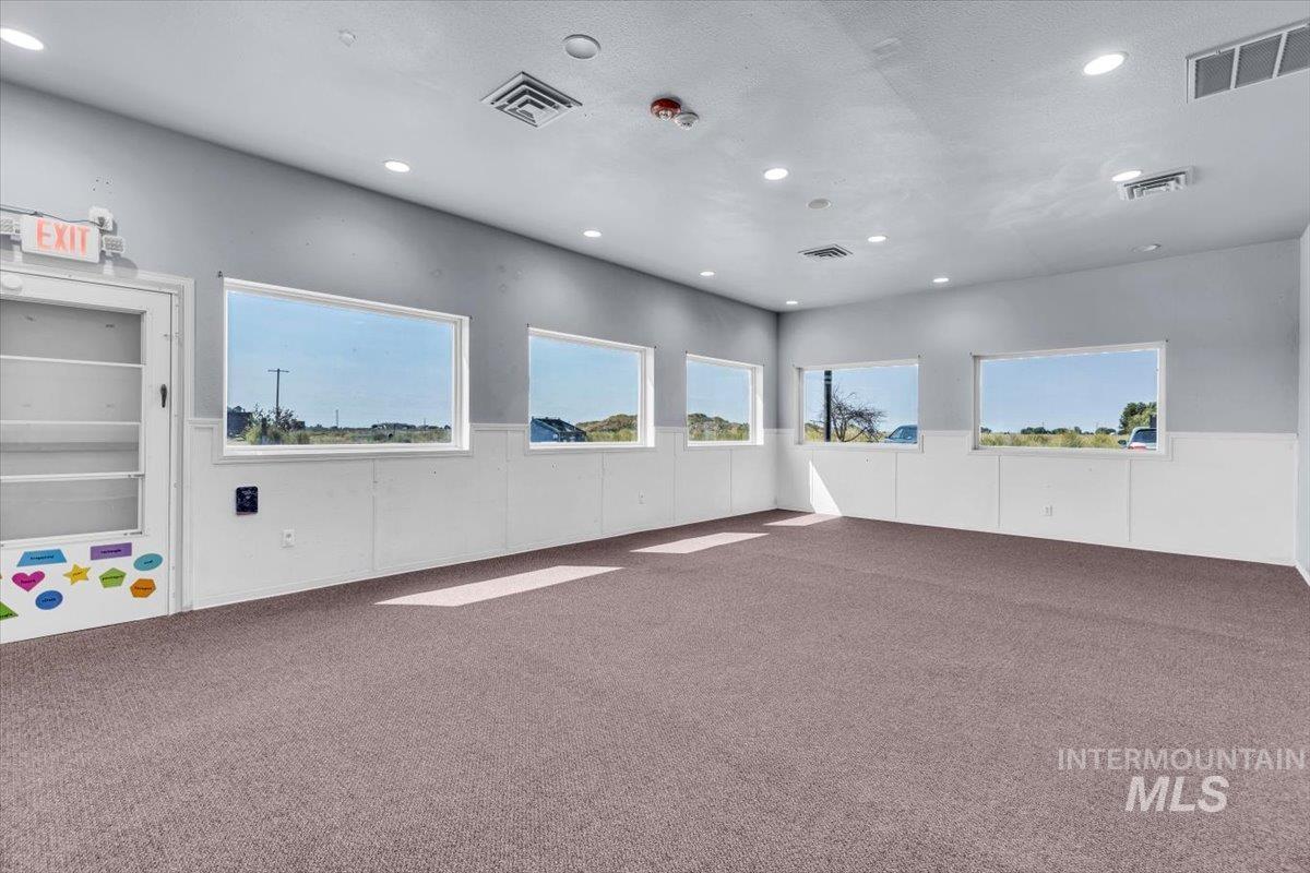 Carpeted spare room featuring recessed lighting