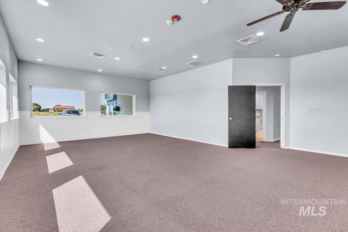 Carpeted spare room with recessed lighting and a ceiling fan