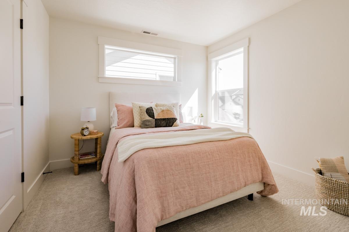 Carpeted bedroom with baseboards