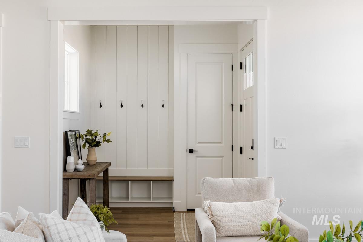 Mudroom featuring plenty of natural light and wood finished floors