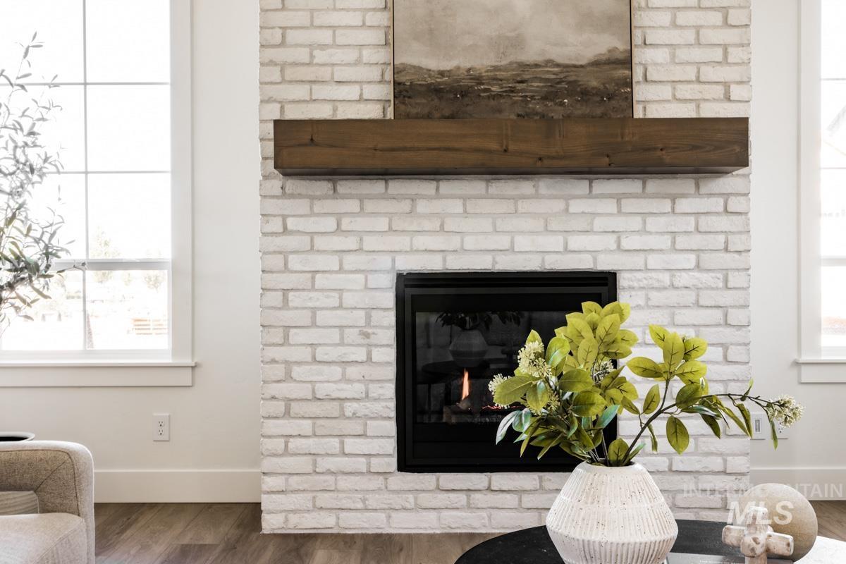 Detailed view of wood finished floors and a fireplace