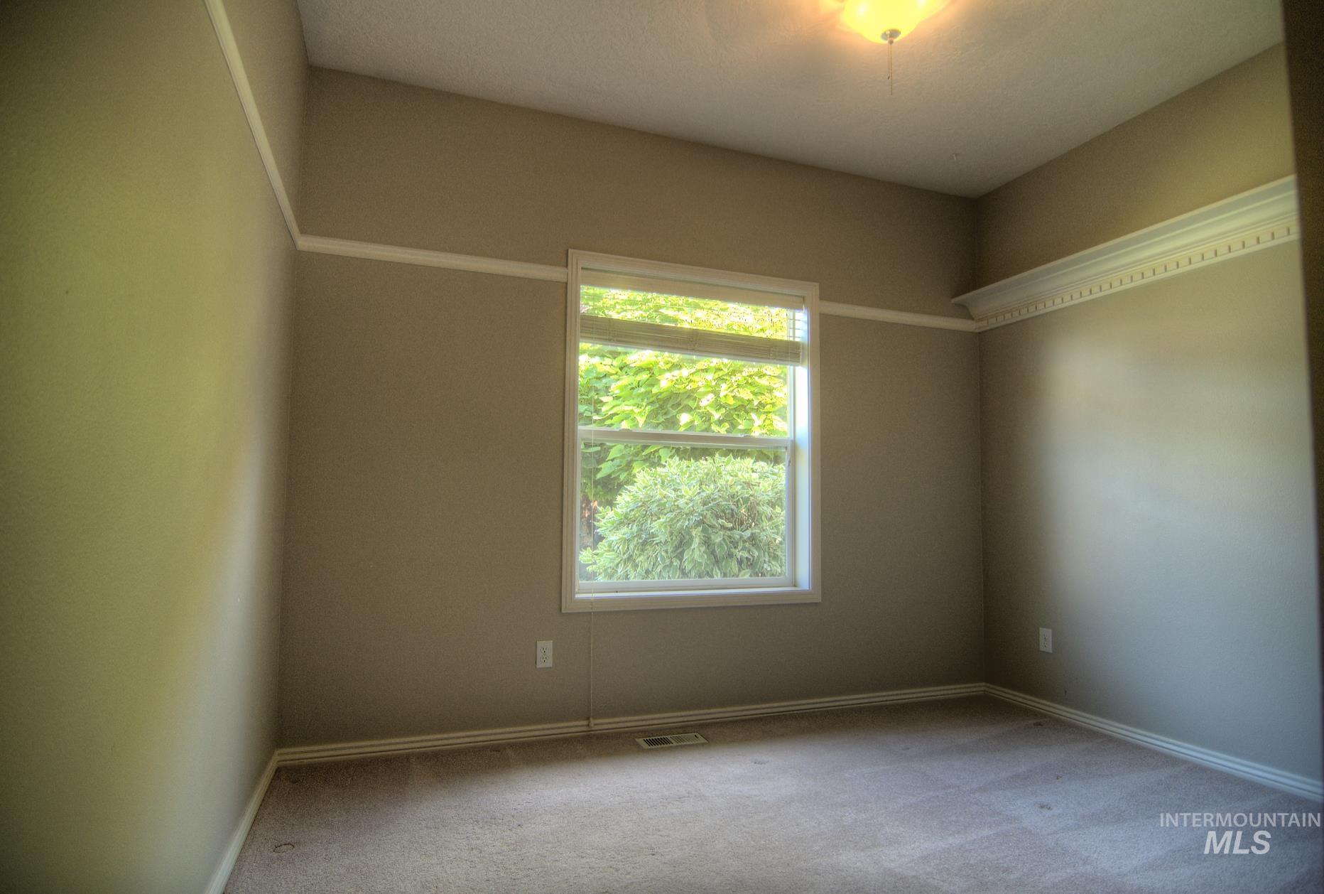 Empty room featuring carpet floors and baseboards