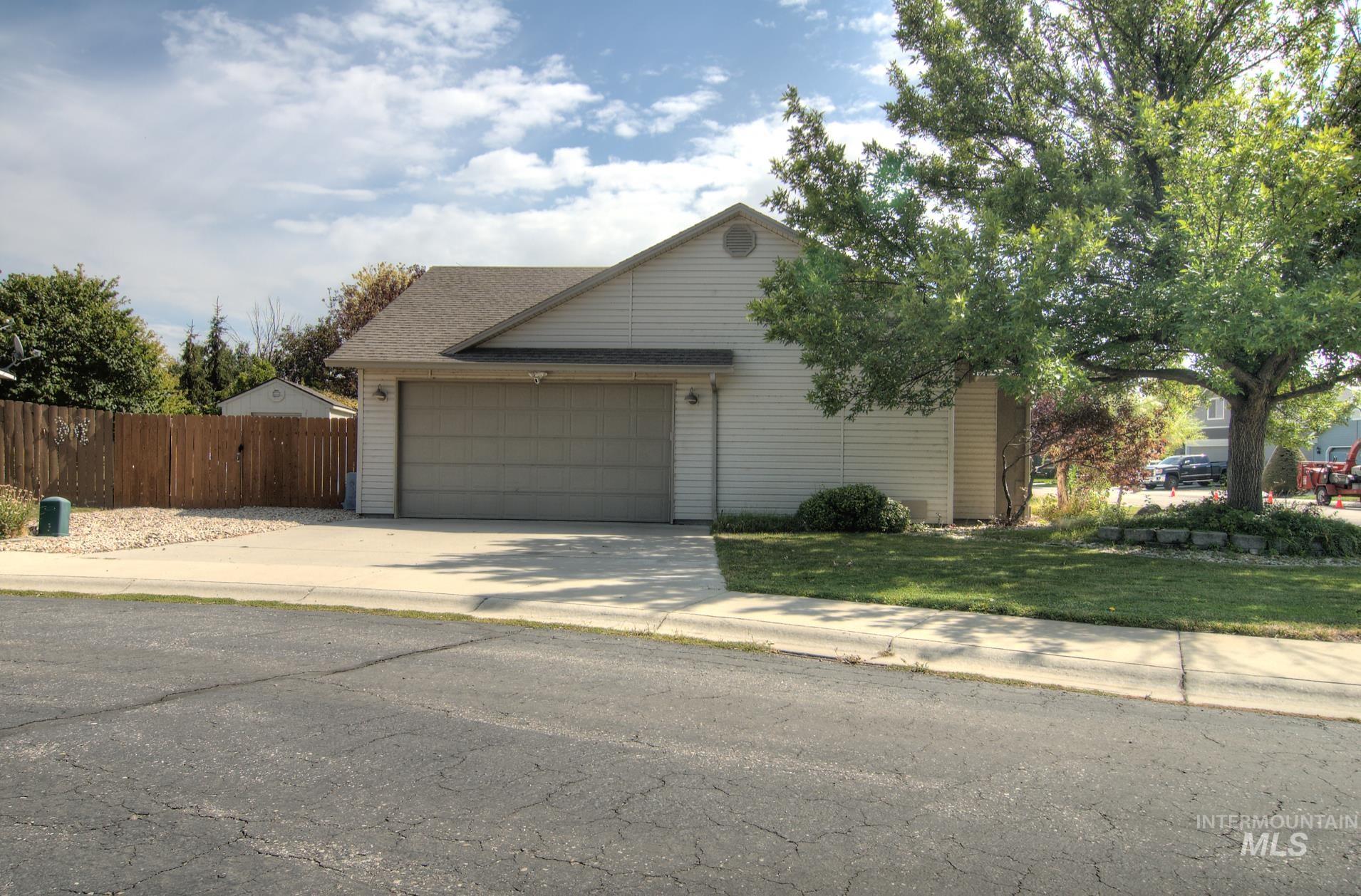 View of front of property with driveway and an attached garage