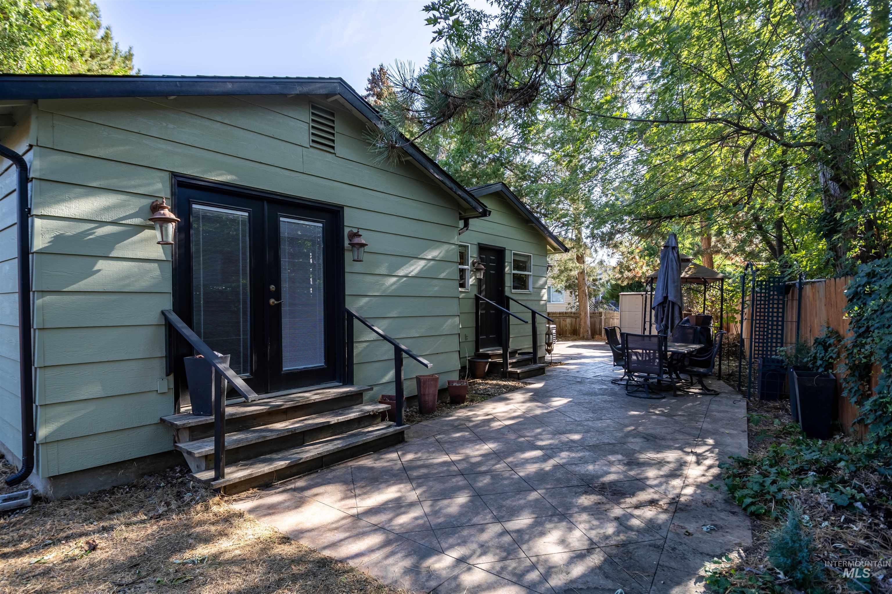 Rear view of property with entry steps and a patio area