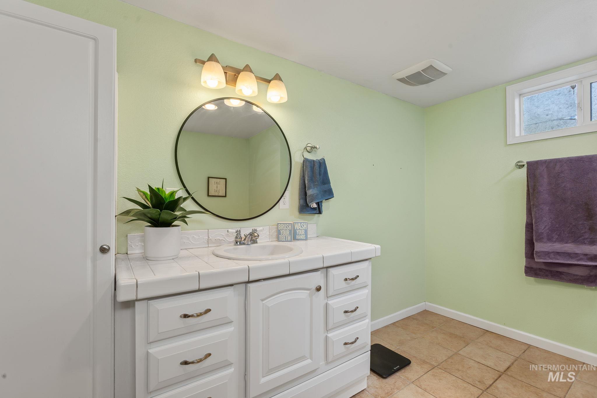 Bathroom with vanity and light tile patterned flooring