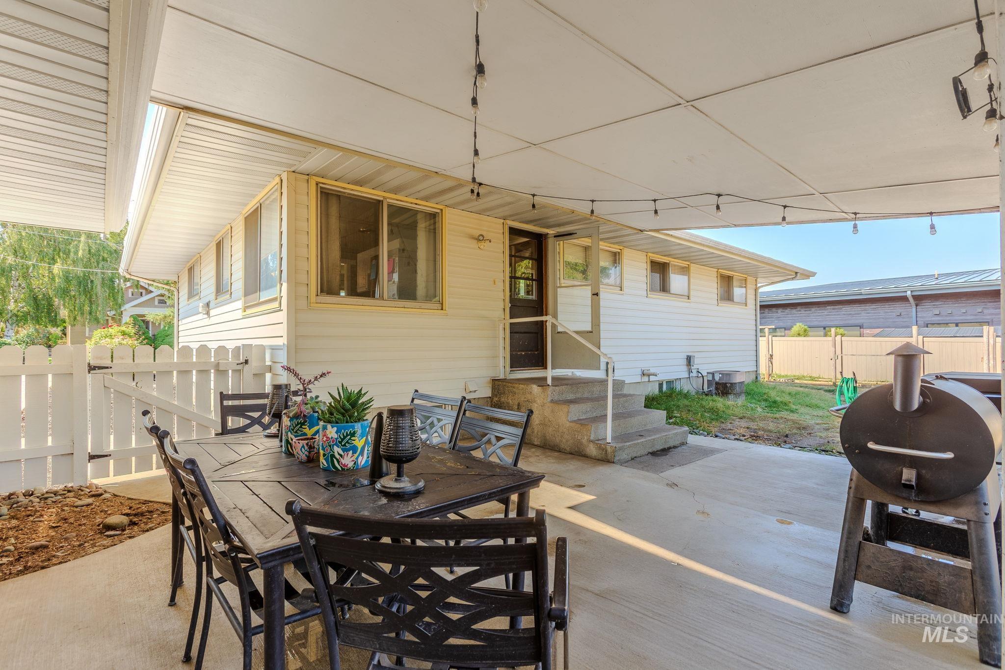 View of patio featuring grilling area, outdoor dining area, and entry steps