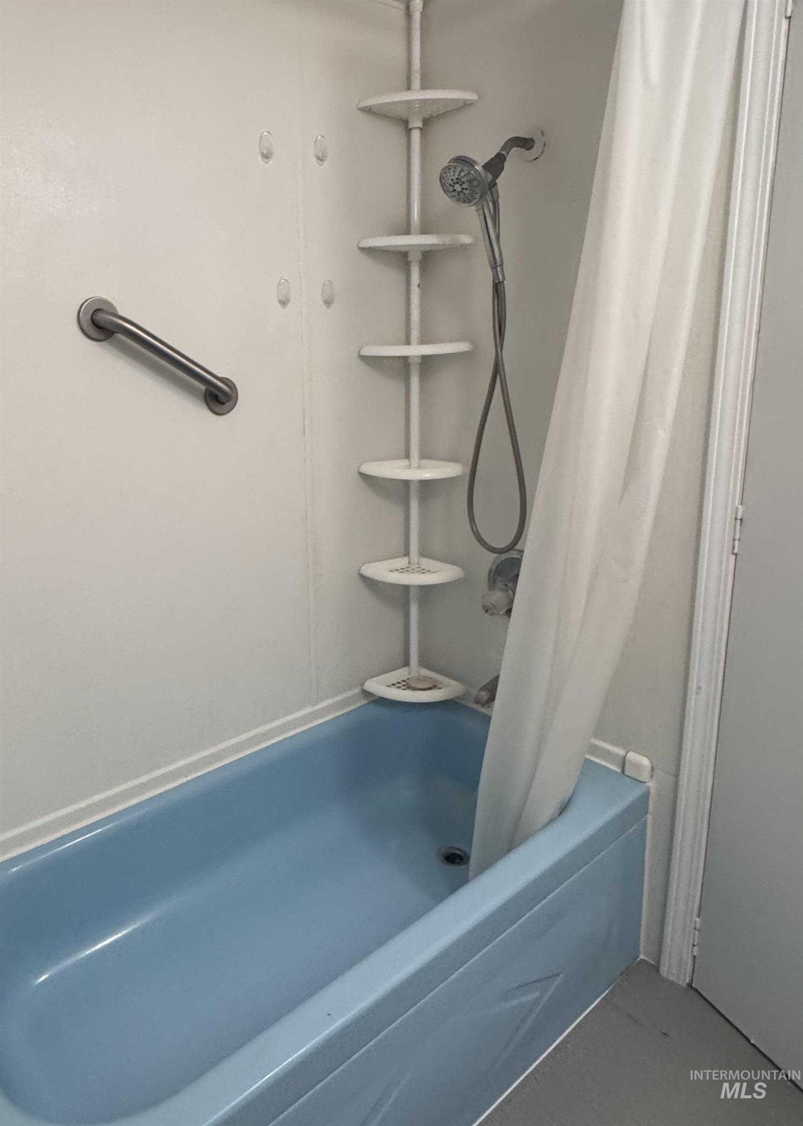 Full bath featuring shower / bath combo with shower curtain