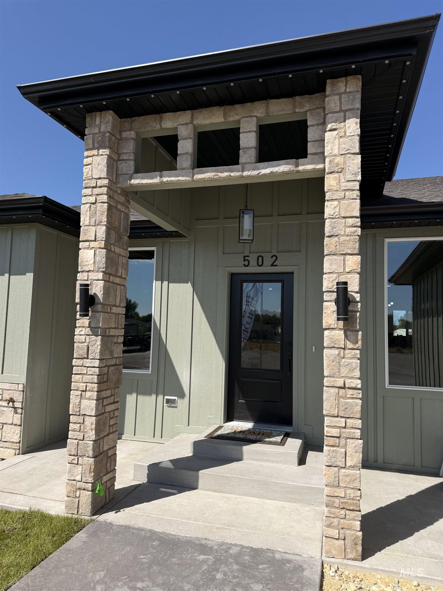 Property entrance featuring stone siding