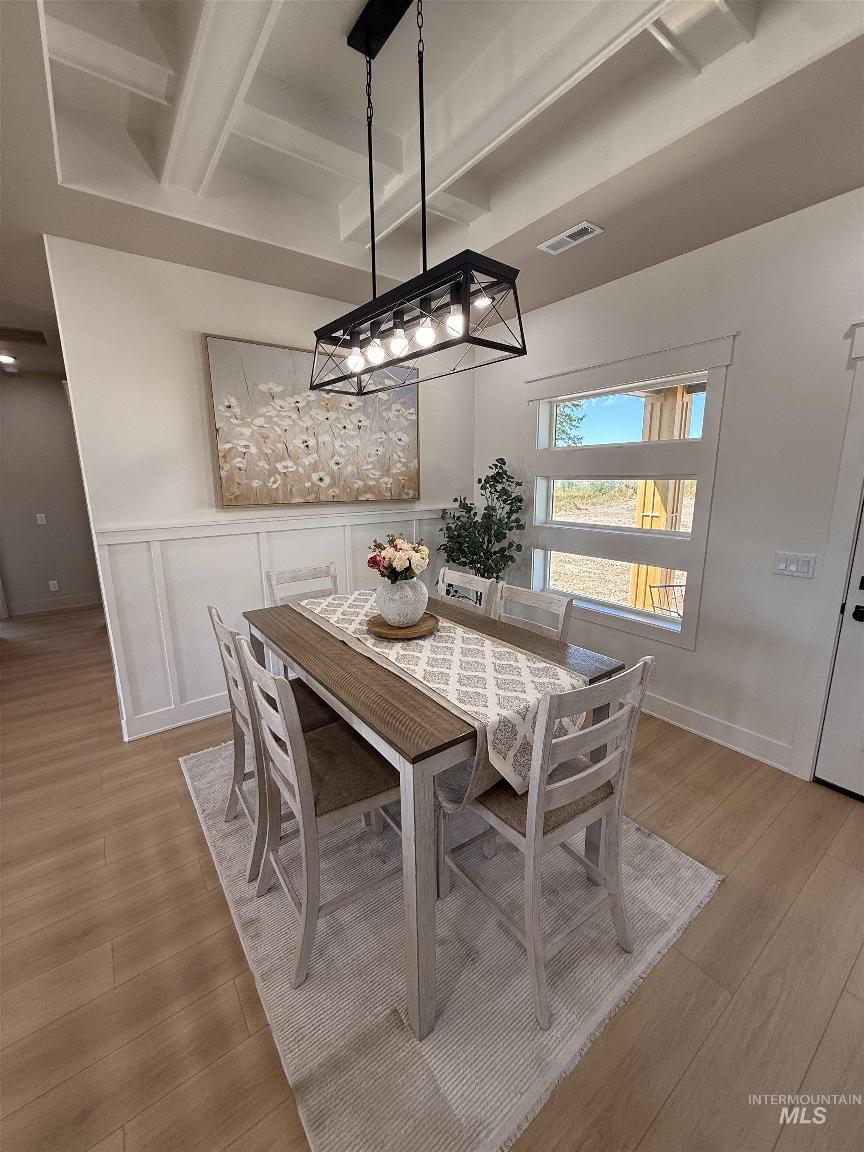 Dining room featuring beam ceiling and light wood-style flooring