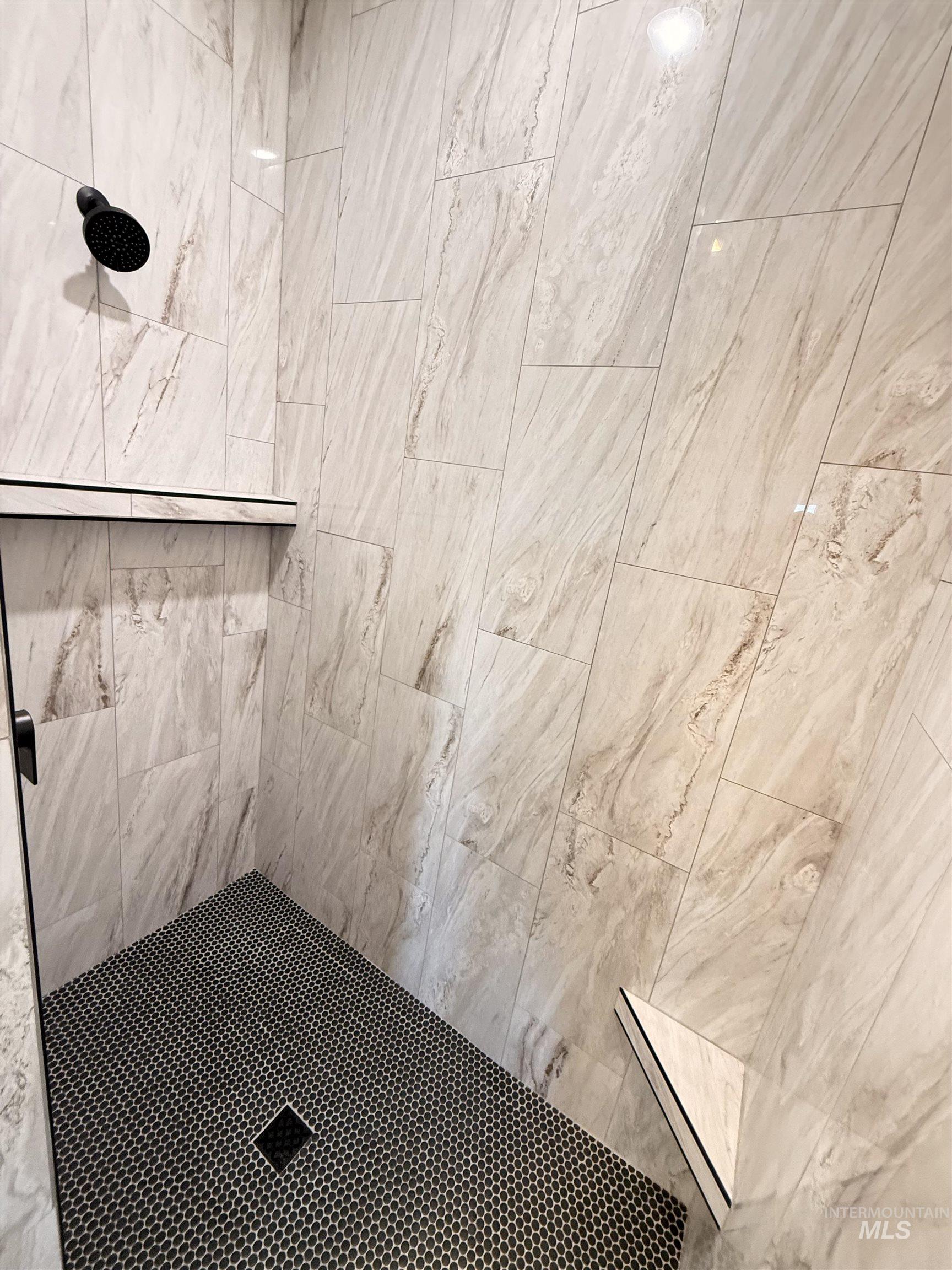 Bathroom view of a tile shower