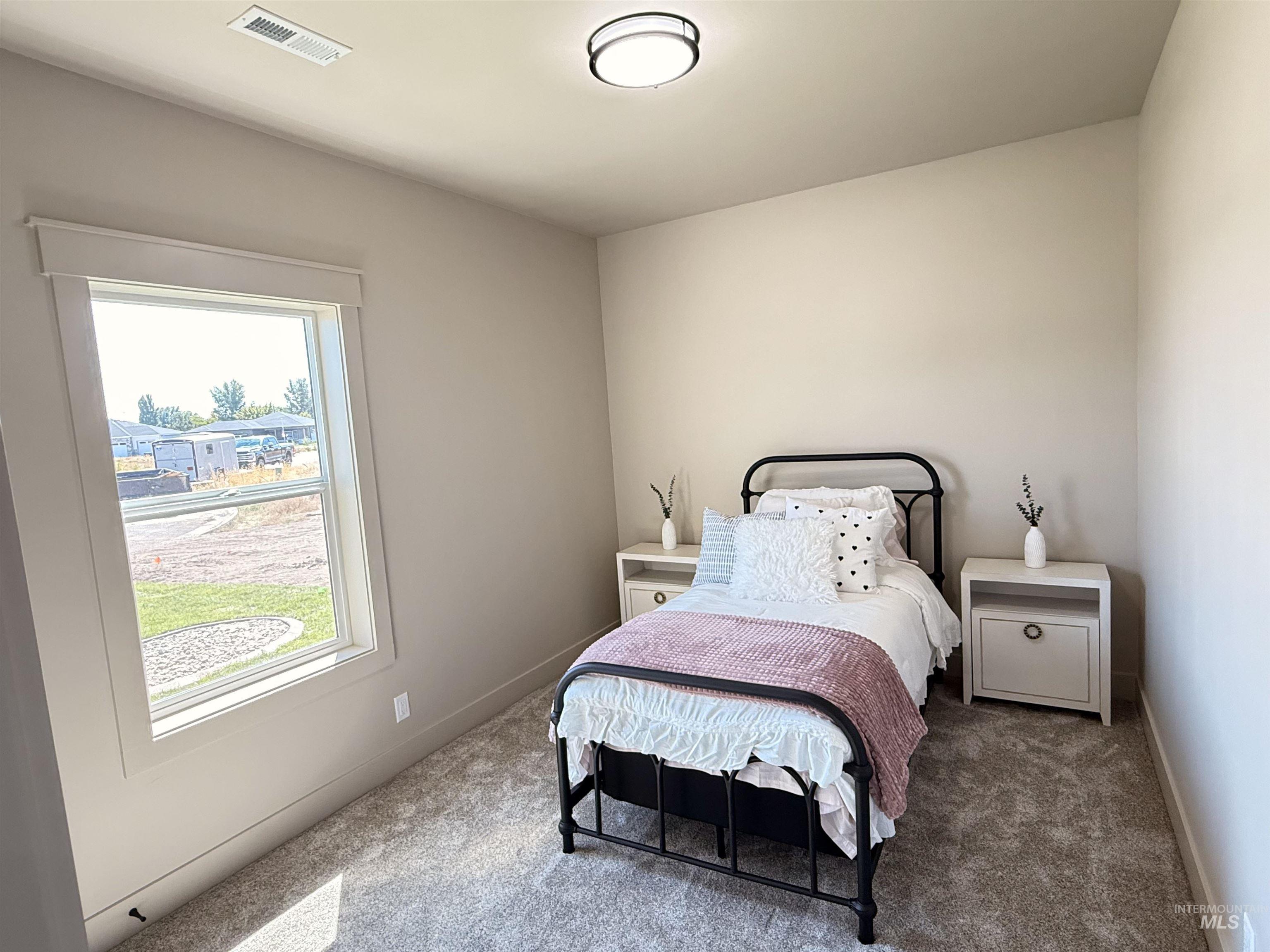 Carpeted bedroom with baseboards