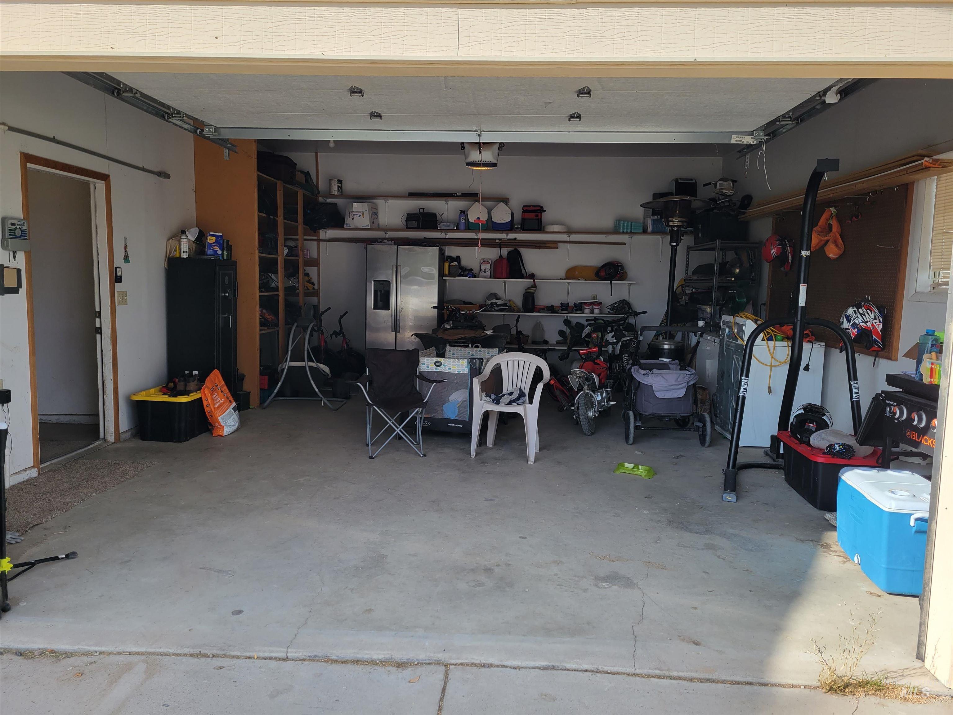 Garage with stainless steel refrigerator with ice dispenser