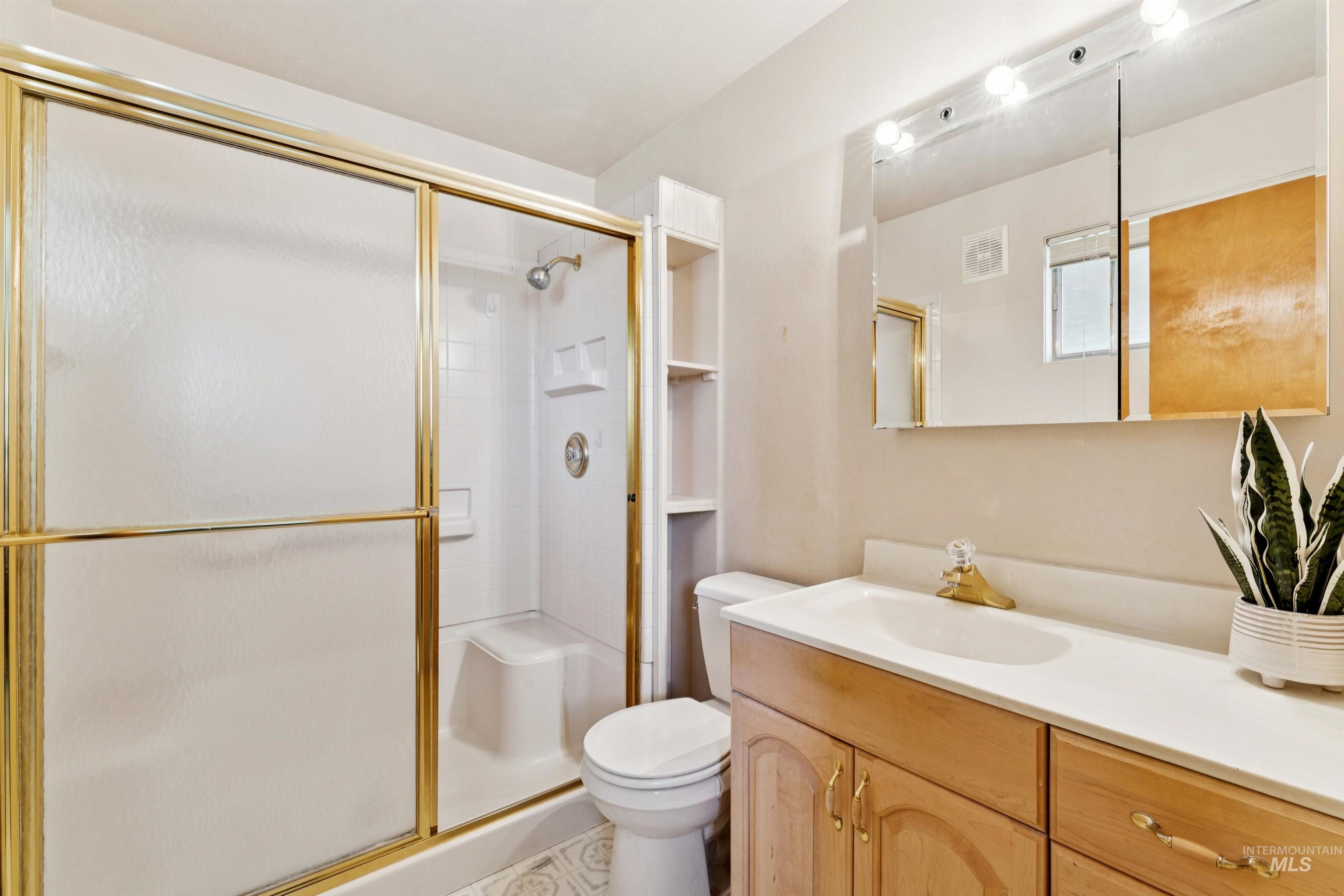Bathroom with a stall shower and vanity