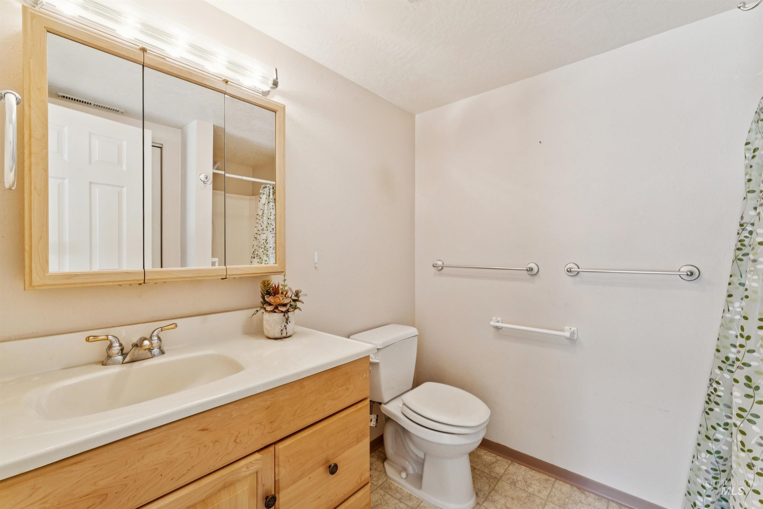 Bathroom featuring vanity and curtained shower