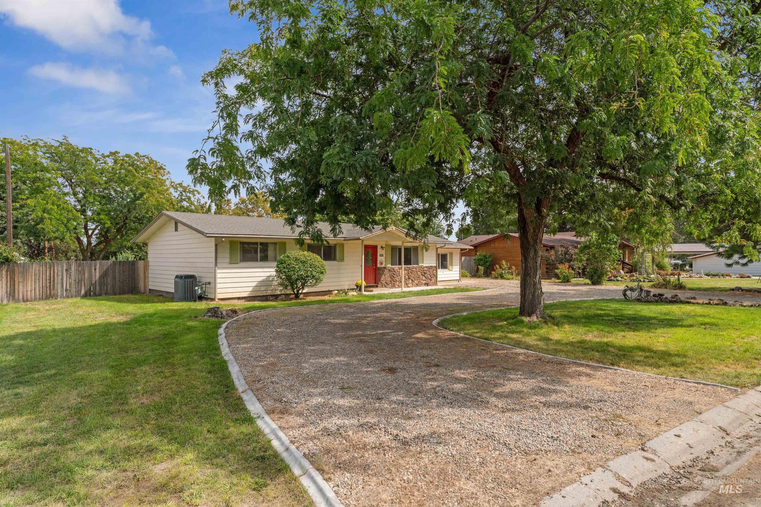 Ranch-style house with dirt driveway