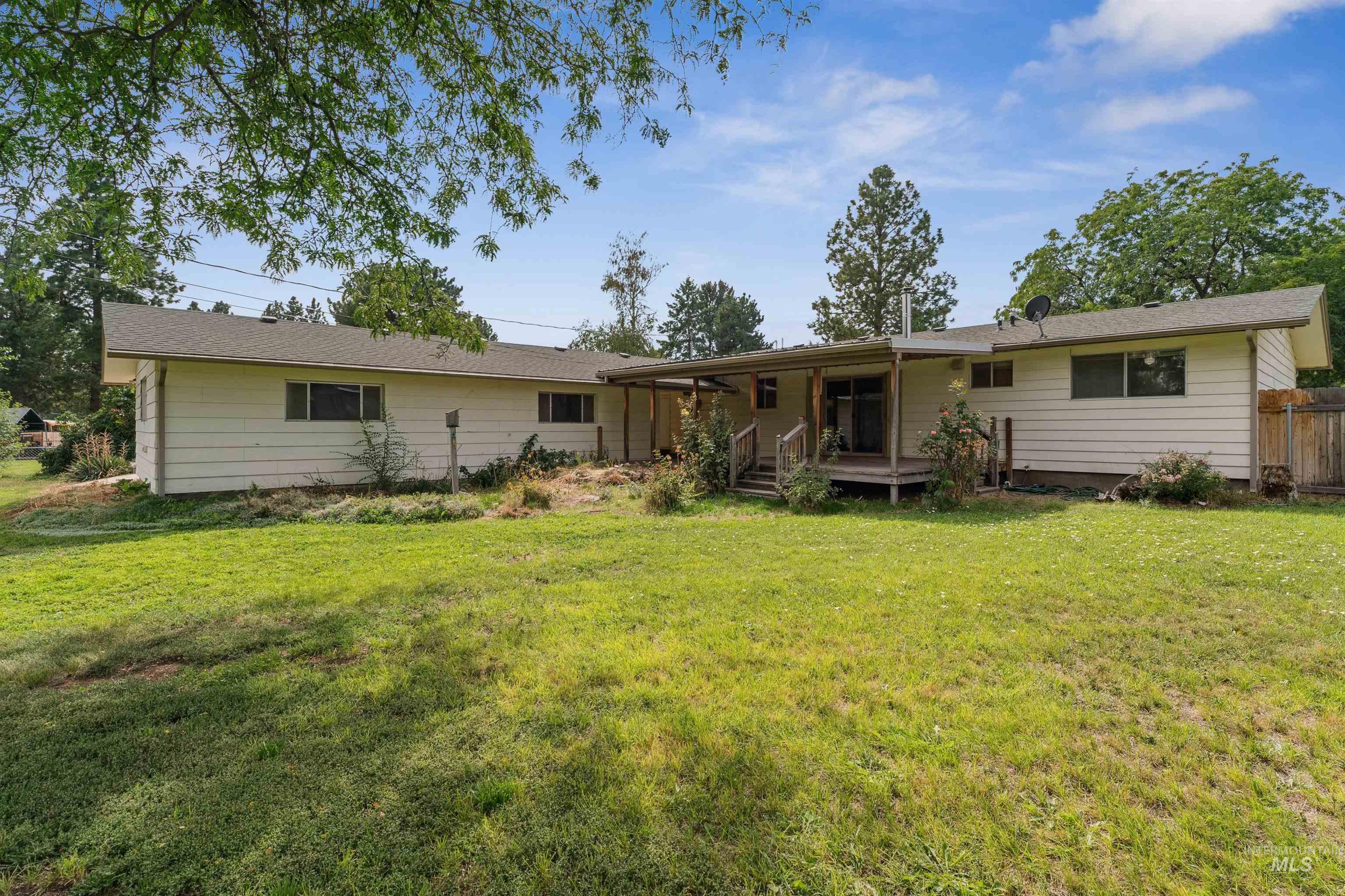 Back of house with a yard