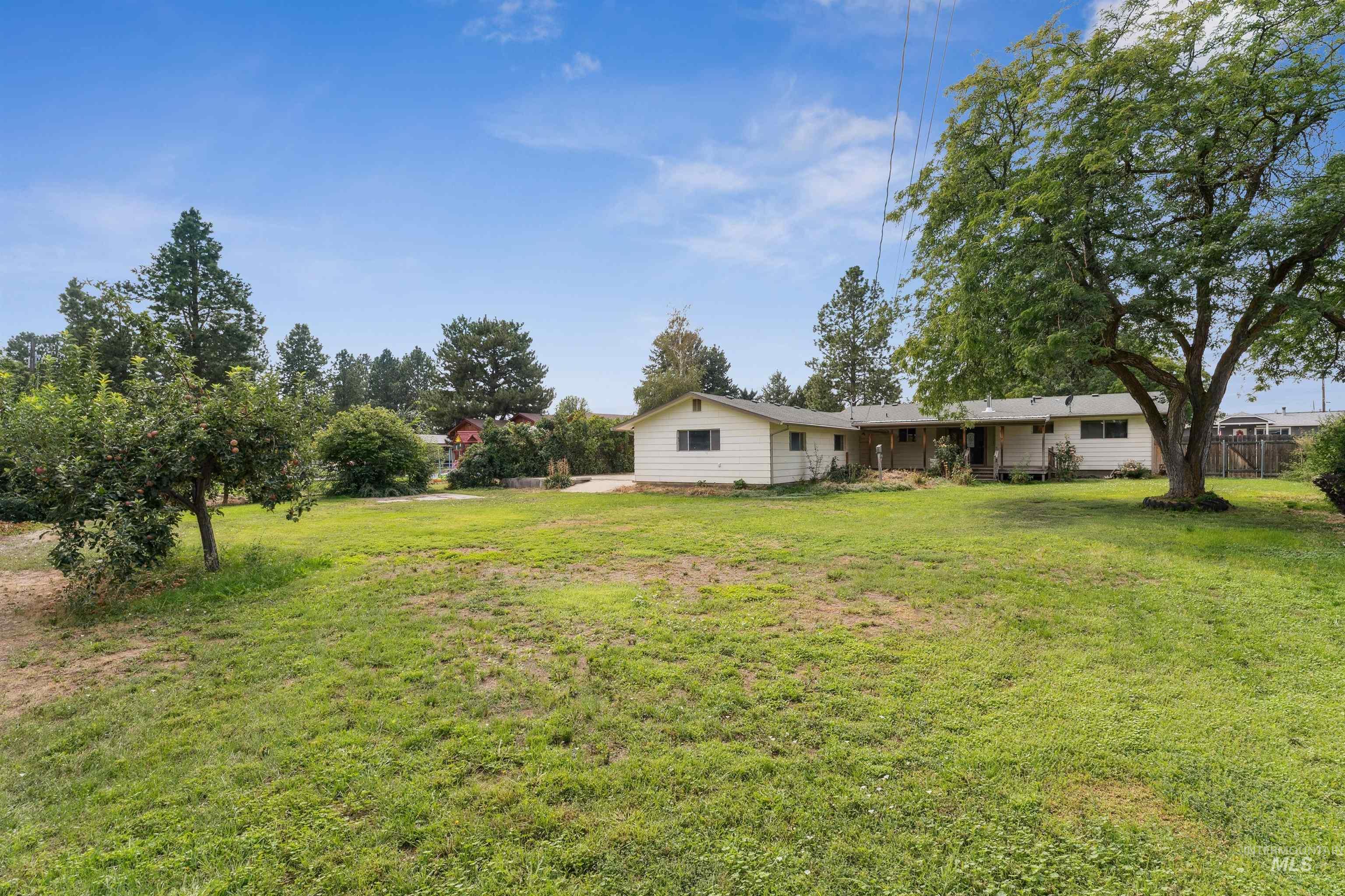 View of grassy yard with a patio area