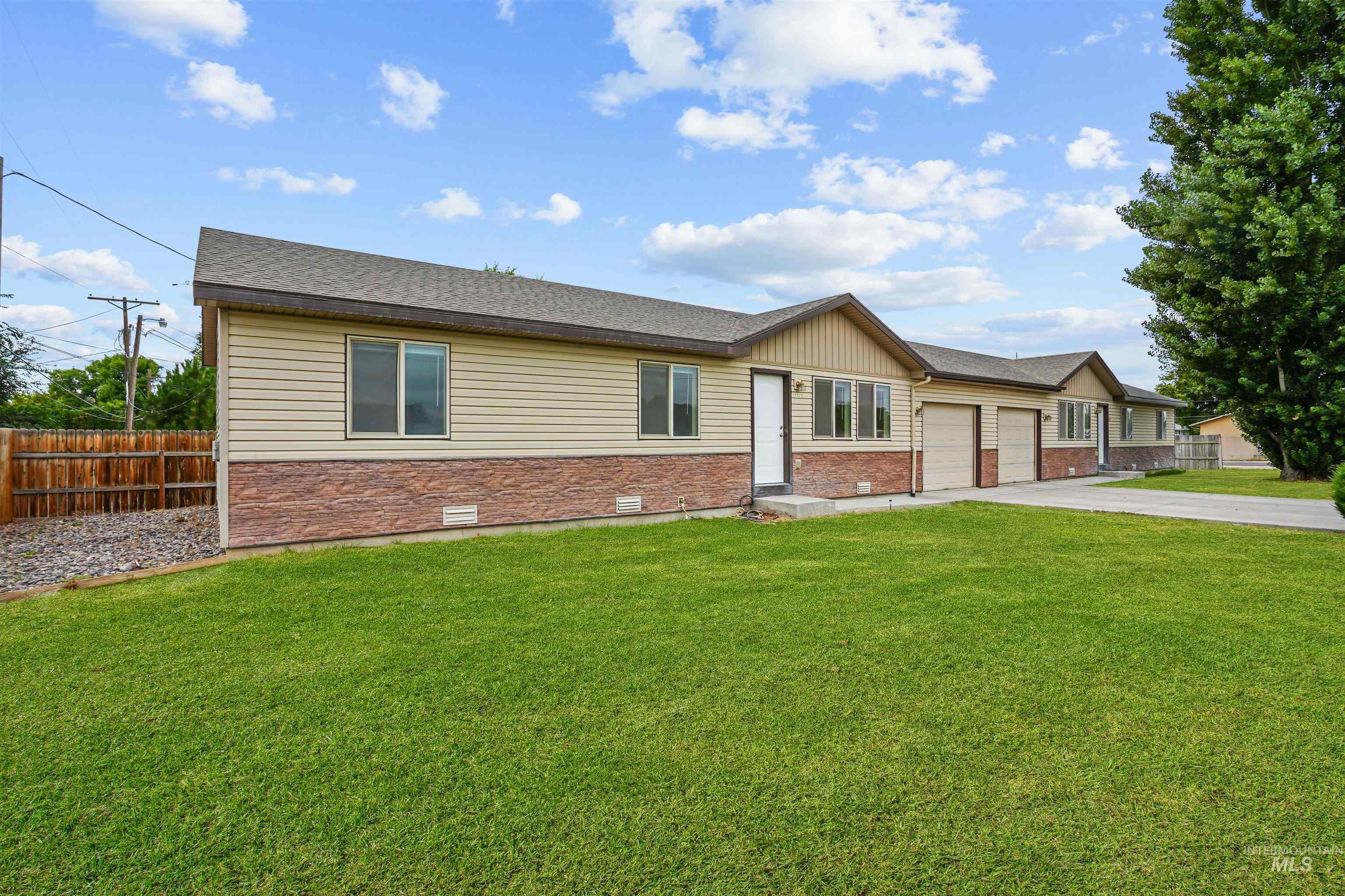 View of front facade featuring concrete driveway, roof with shingles, brick siding, crawl space, and a garage