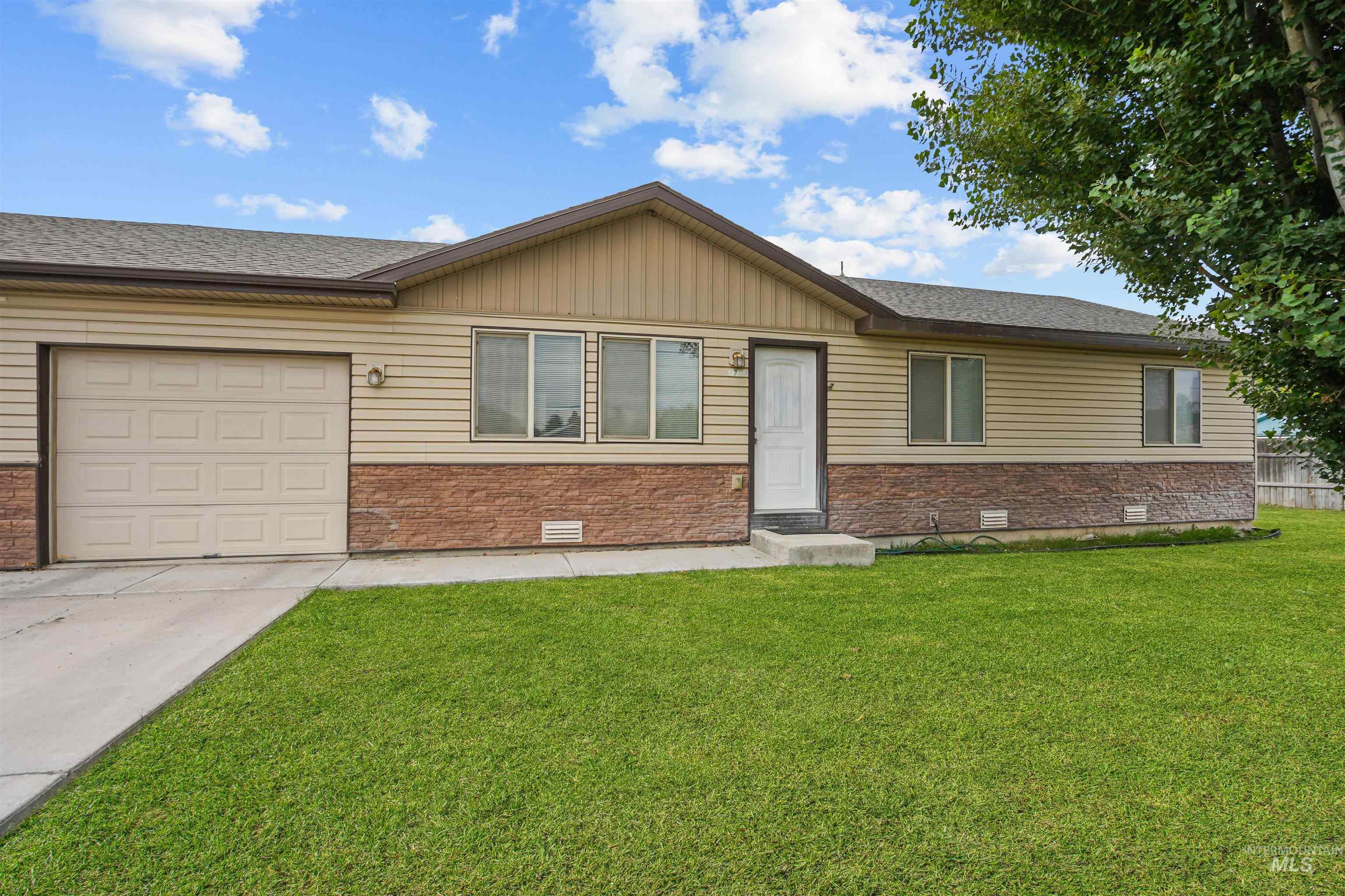 Ranch-style house featuring crawl space, a front yard, roof with shingles, and brick siding