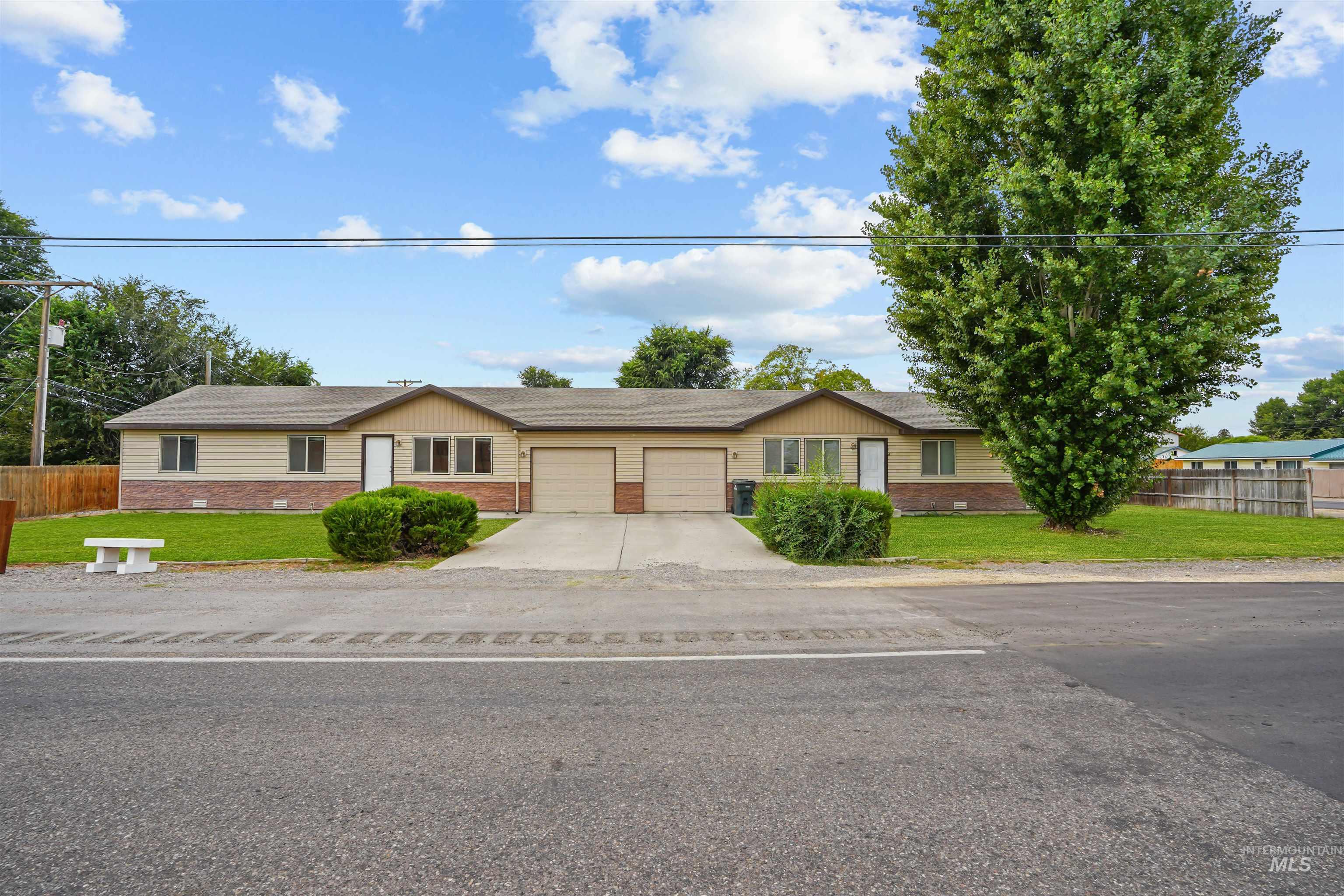 Single story home with brick siding, a shingled roof, driveway, and an attached garage