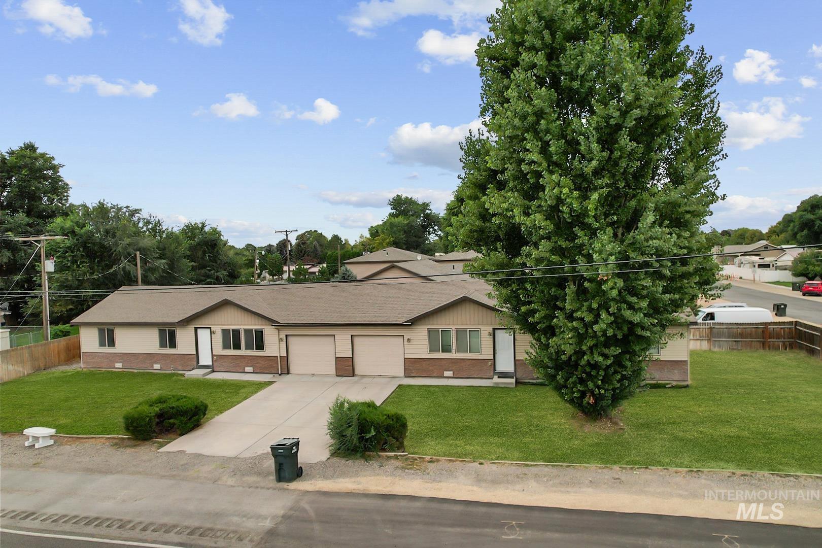 Ranch-style home featuring brick siding, driveway, and an attached garage