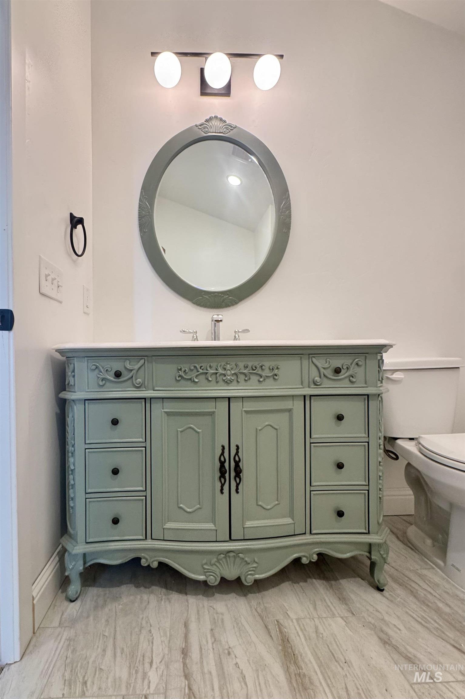 Half bathroom featuring vanity and toilet