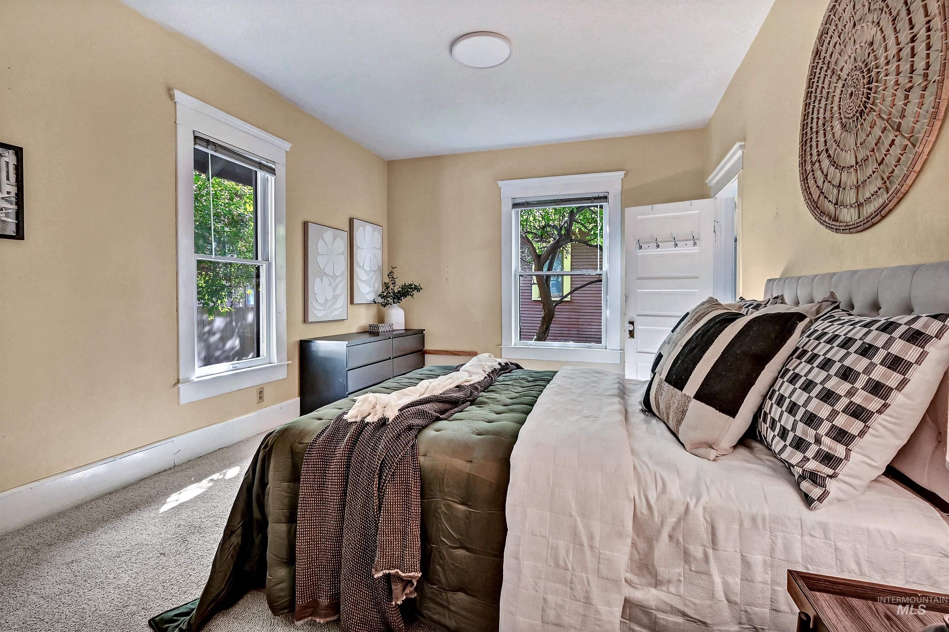 Main floor bedroom with several windows looking out to the back and side yards.