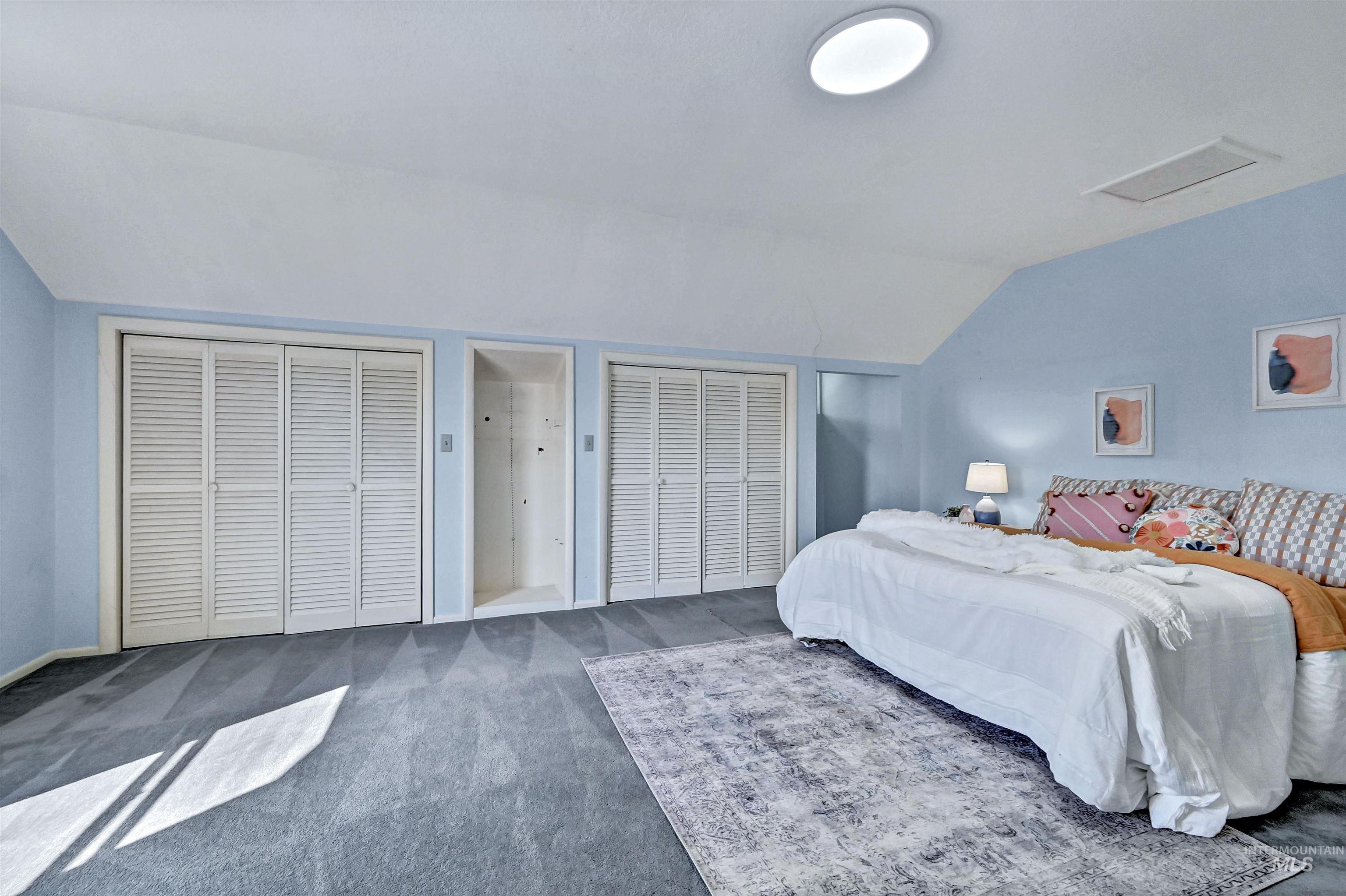 Gigantic upstairs bedroom featuring two closets