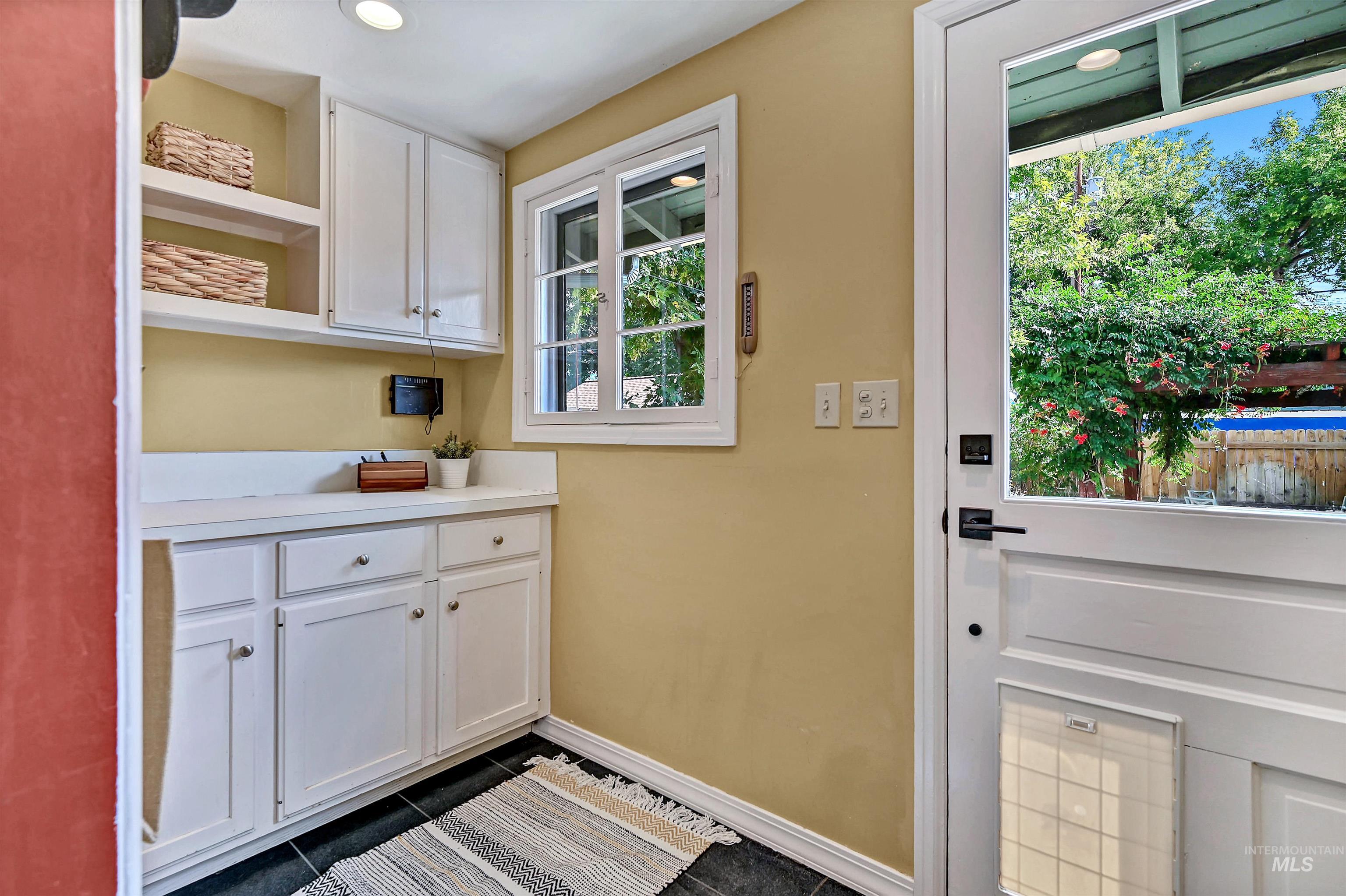 Mudroom with storage off the kitchen with a door to the back yard