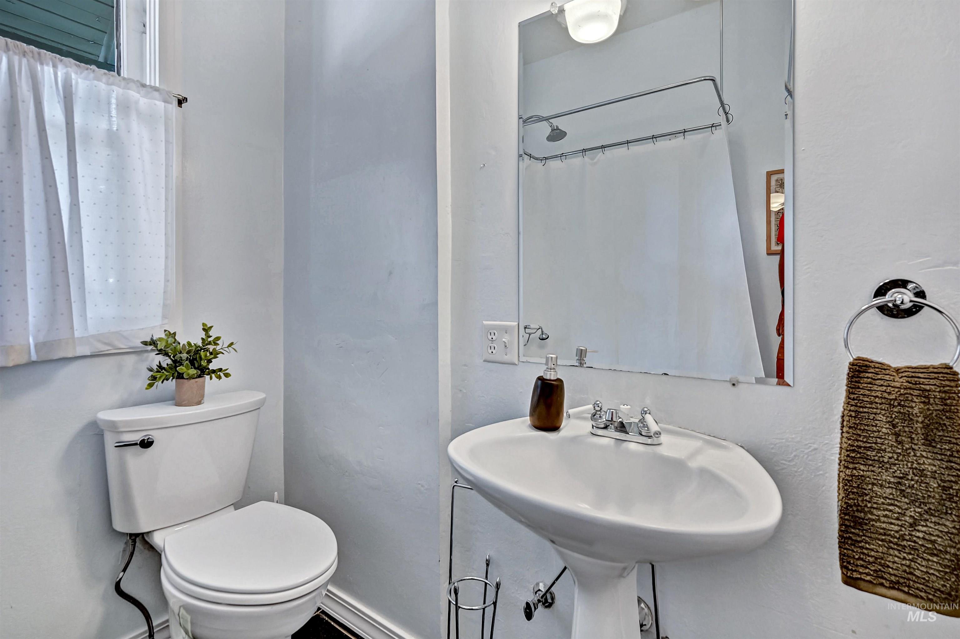 Main floor bathroom with claw foot tub & pedestal sink