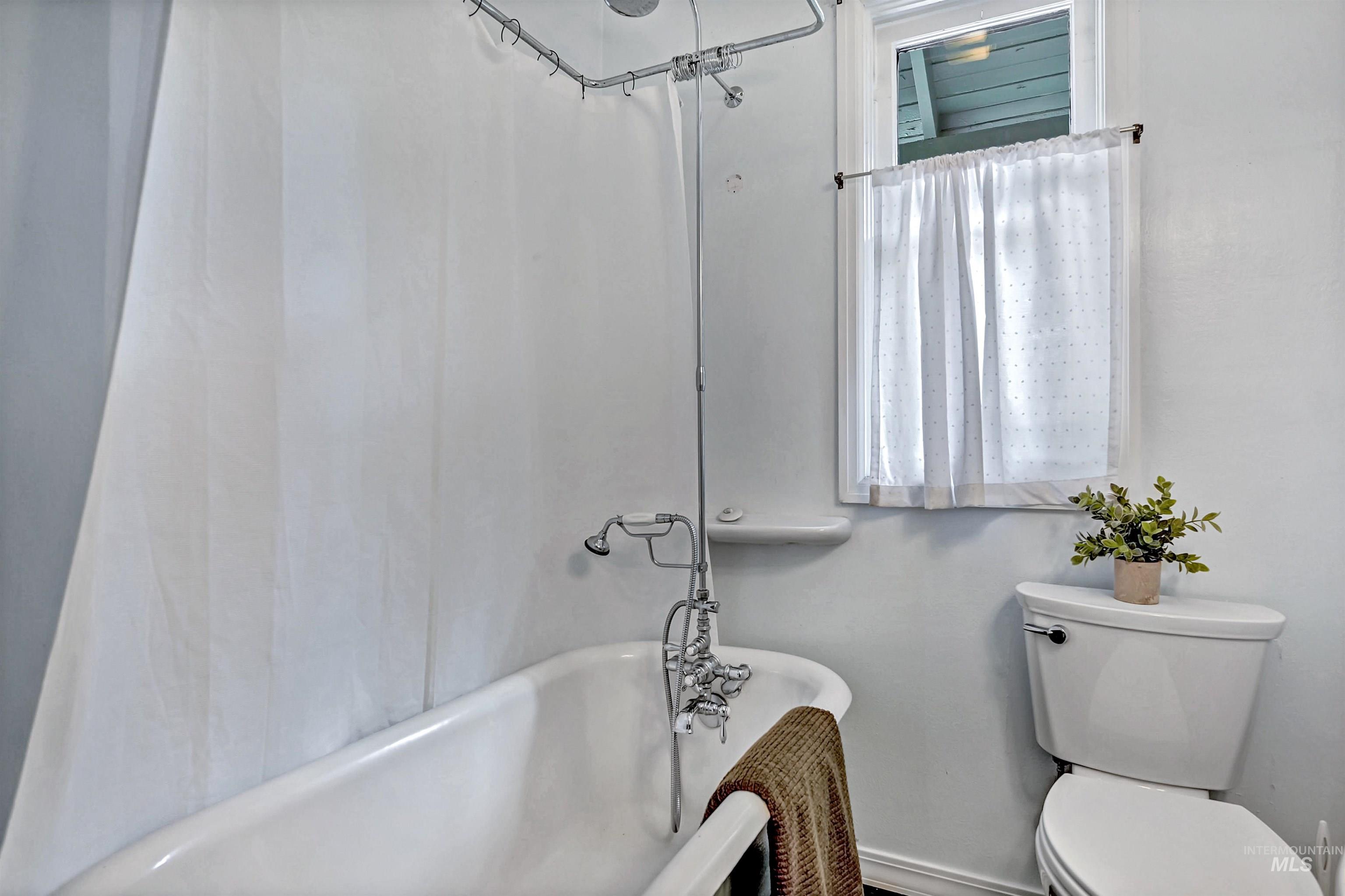 Main floor bathroom with claw foot tub & pedestal sink
