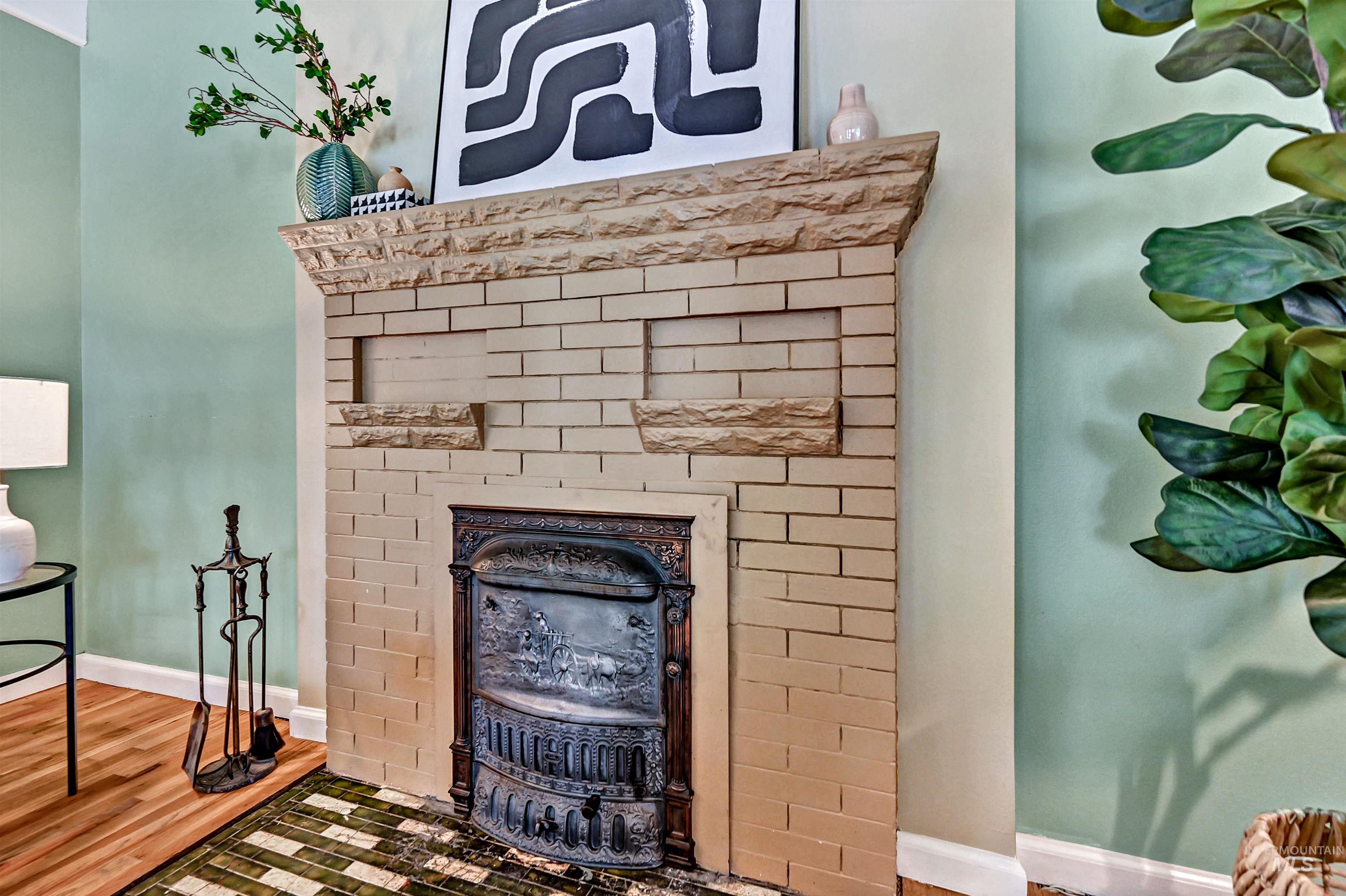 Original Dawson Brothers cast iron fireplace with brick mantle and Craftsman-style tile hearth