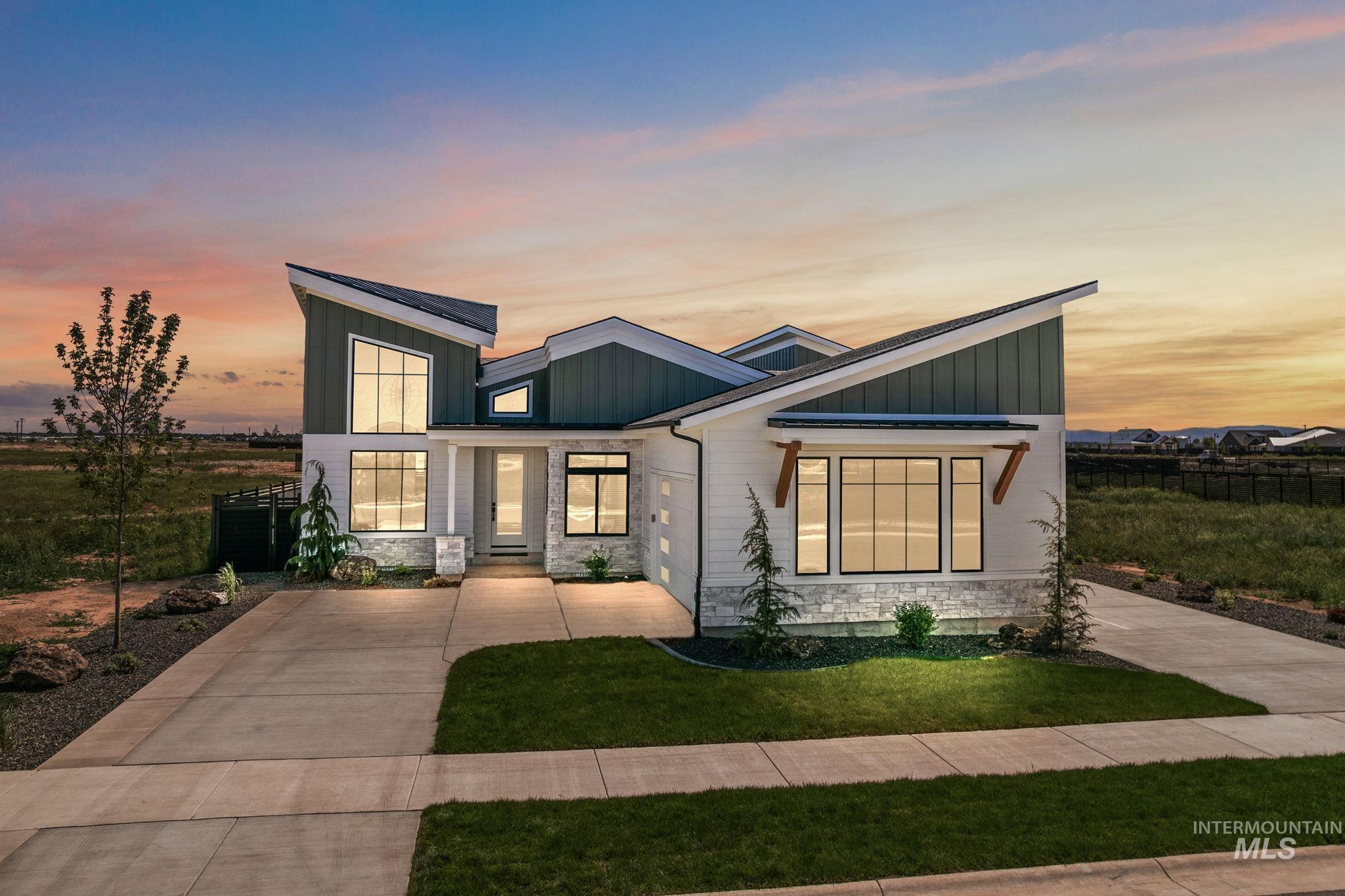 Contemporary home featuring stone siding, board and batten siding, and driveway