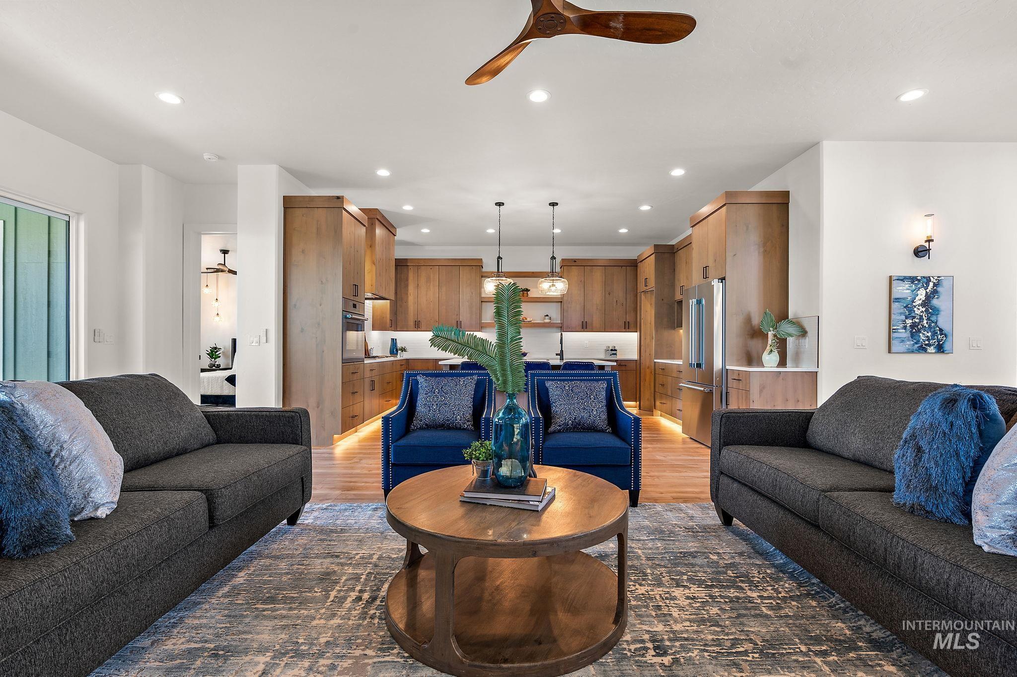 Living area featuring light wood-style floors, recessed lighting, and a ceiling fan