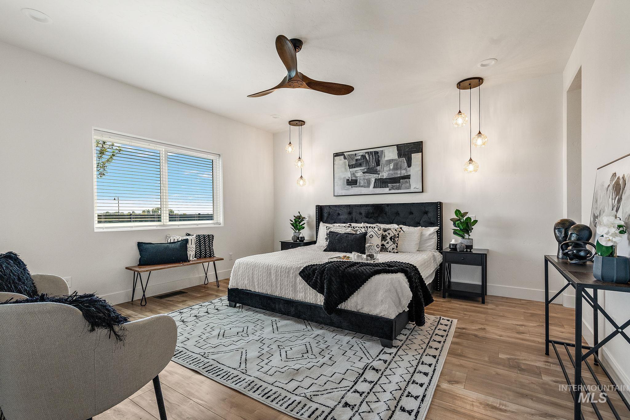 Bedroom with wood finished floors and a ceiling fan