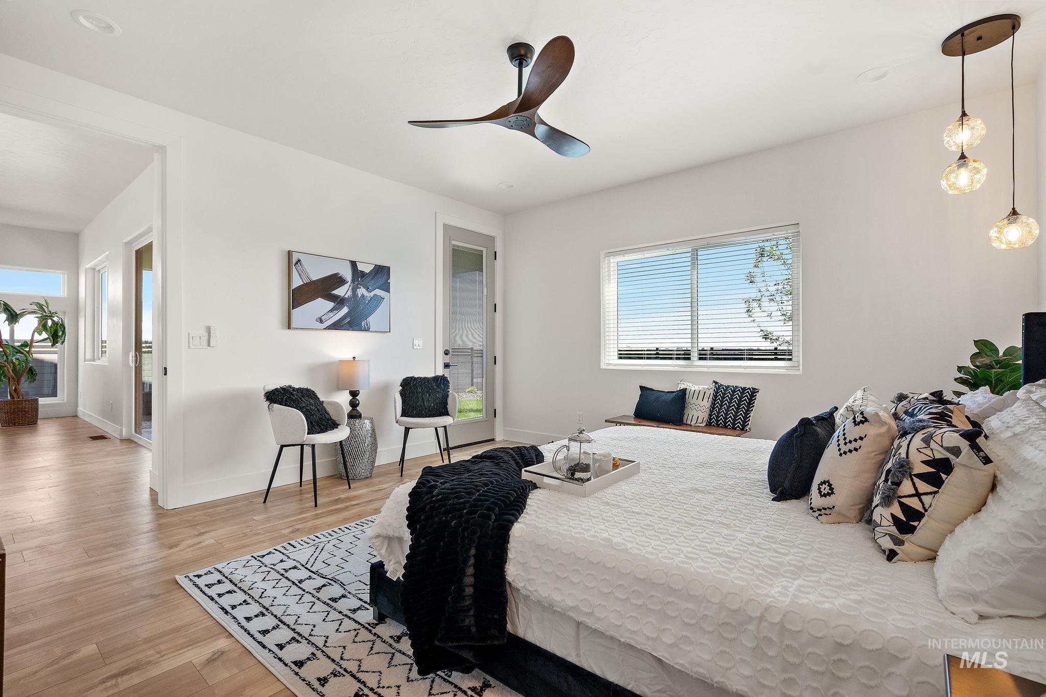 Bedroom with light wood-style floors, access to outside, and ceiling fan