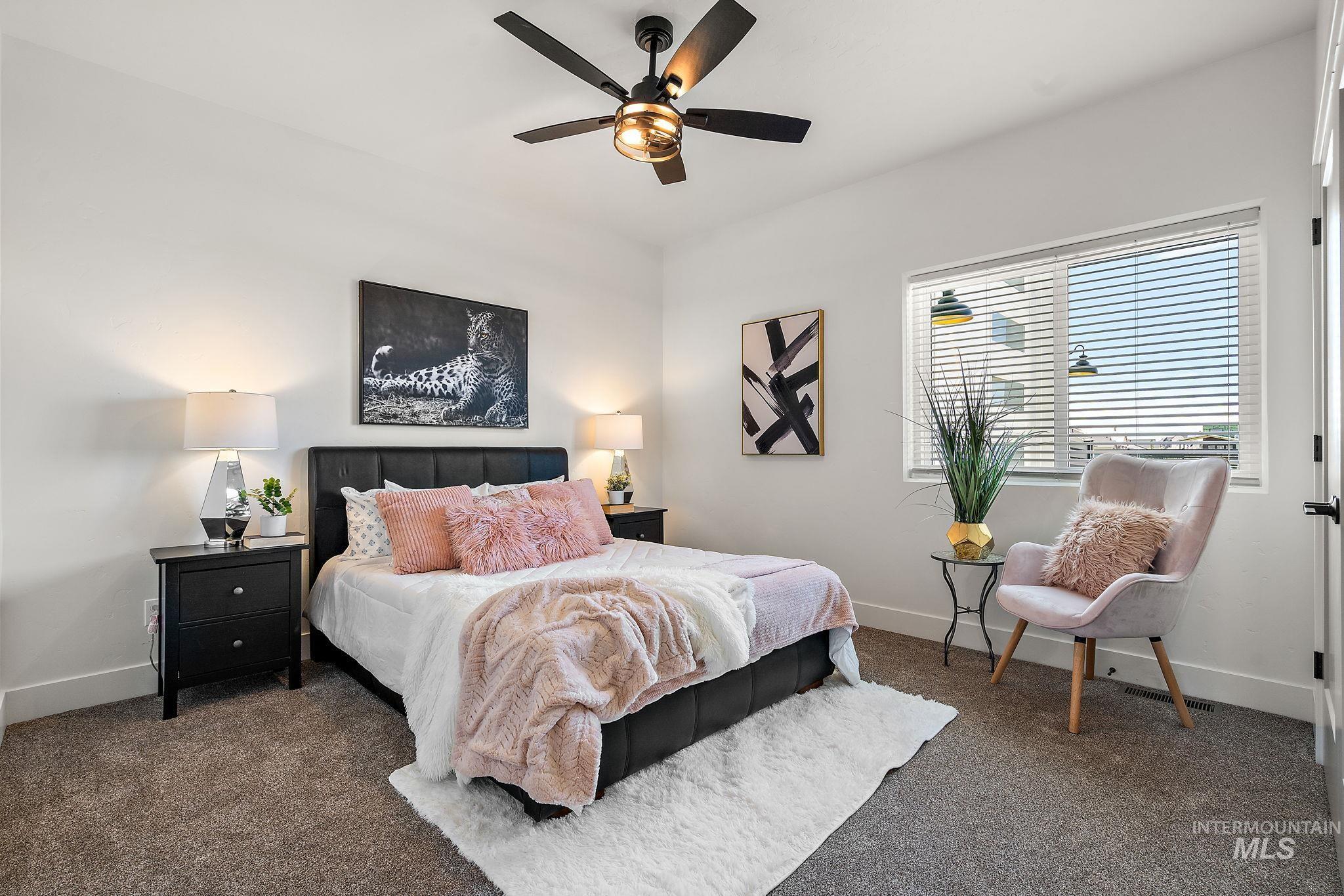 Bedroom with dark colored carpet and ceiling fan