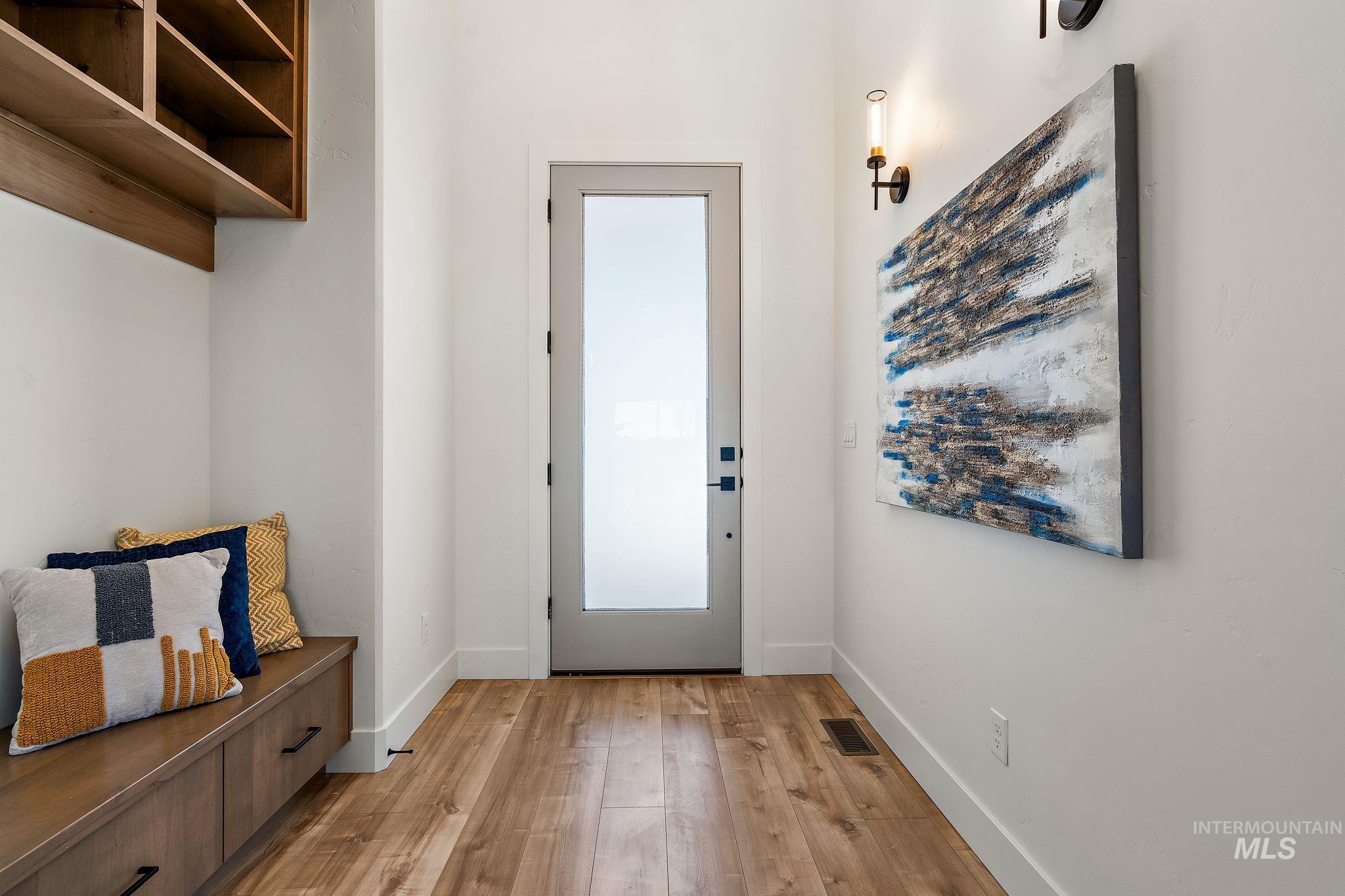 Mudroom with light wood-type flooring and baseboards