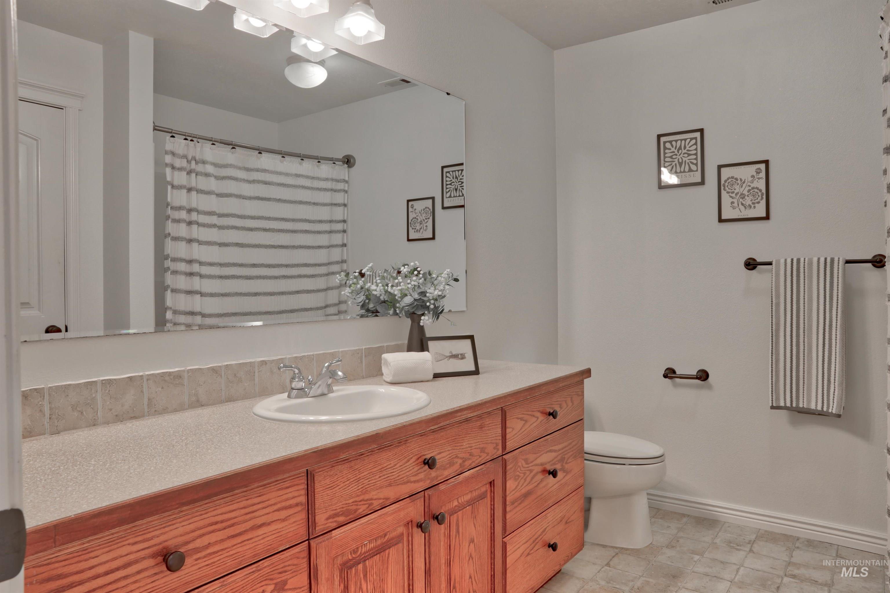 Full bath featuring vanity and a shower with curtain